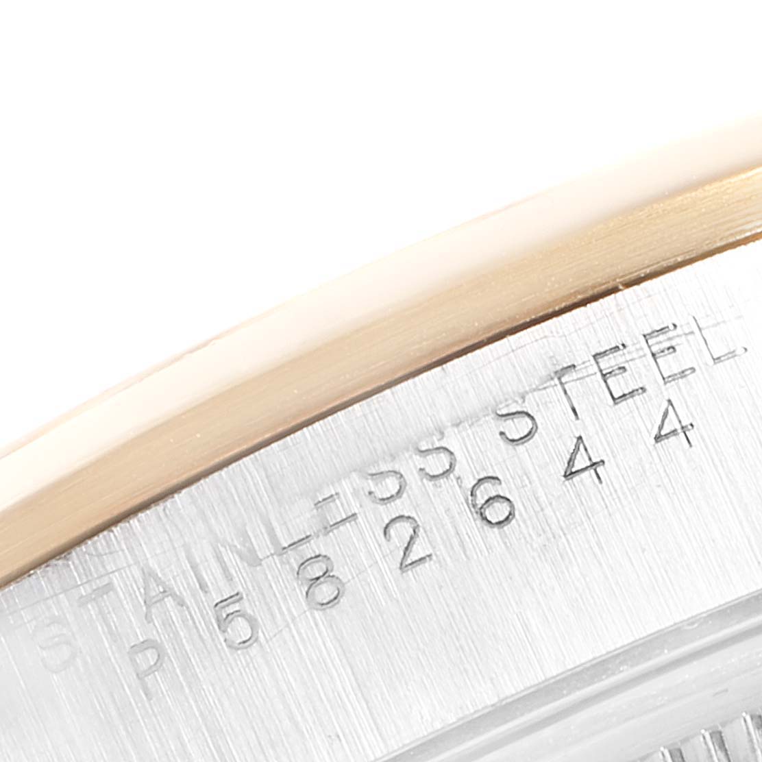 This close-up image of a Rolex Oyster Perpetual 14203 Men's Steel and Gold (two tone) Grey Dial 14203 Men's Steel and Gold (two tone) Grey Dial watch shows the edge of the case, revealing the stainless steel marking.