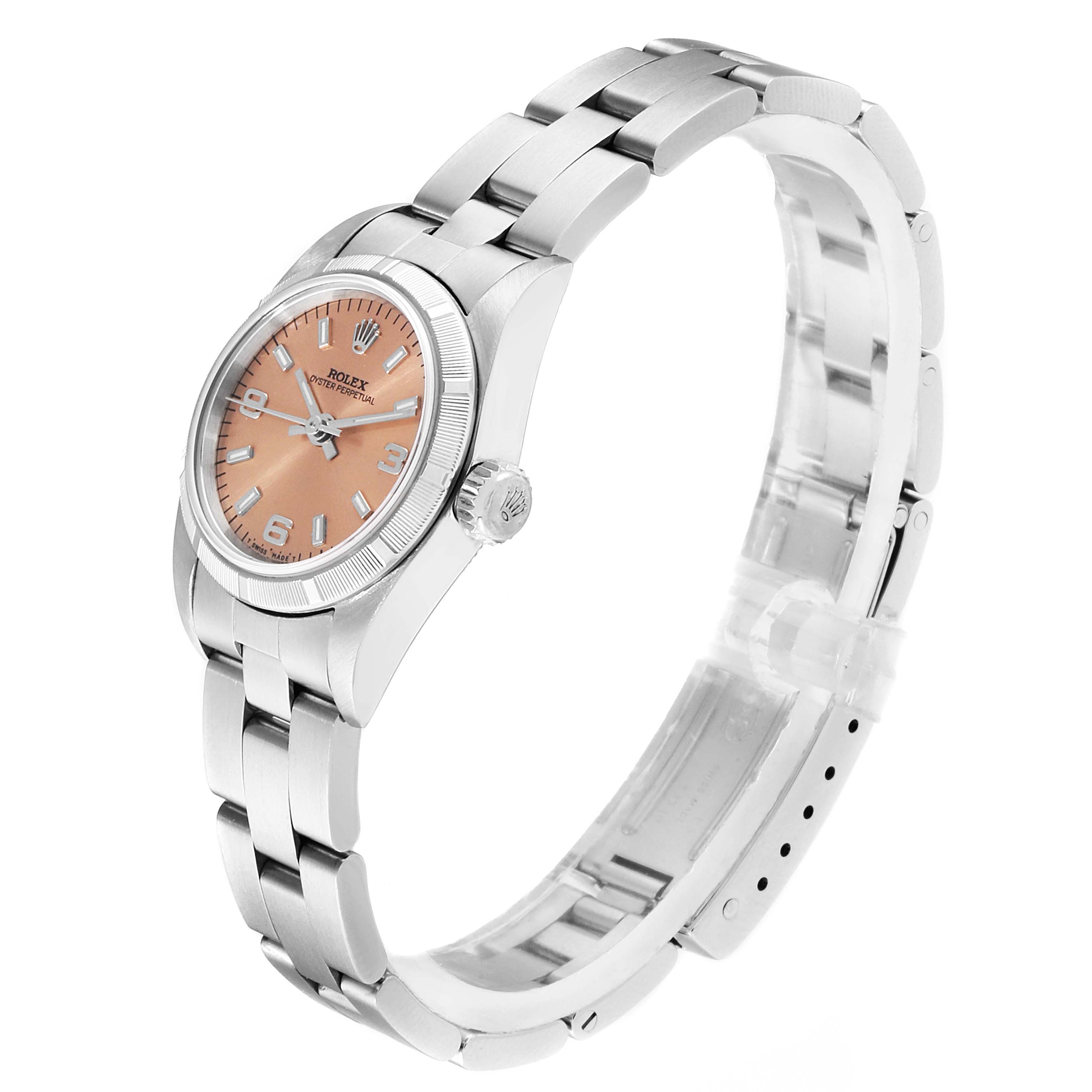 This Rolex Oyster Perpetual 67230 Women's Stainless Steel Pink Dial 67230 Women's Stainless Steel Pink Dial watch is shown from a side angle, displaying its band, case, crown, and face.