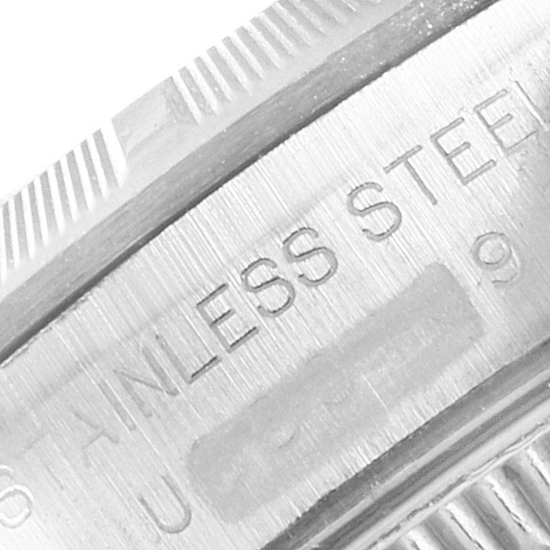 This is a close-up view of the casing and bezel of a Rolex Oyster Perpetual 67230 Women's Stainless Steel Pink Dial 67230 Women's Stainless Steel Pink Dial, showing "STAINLESS STEEL" engraved on the side.