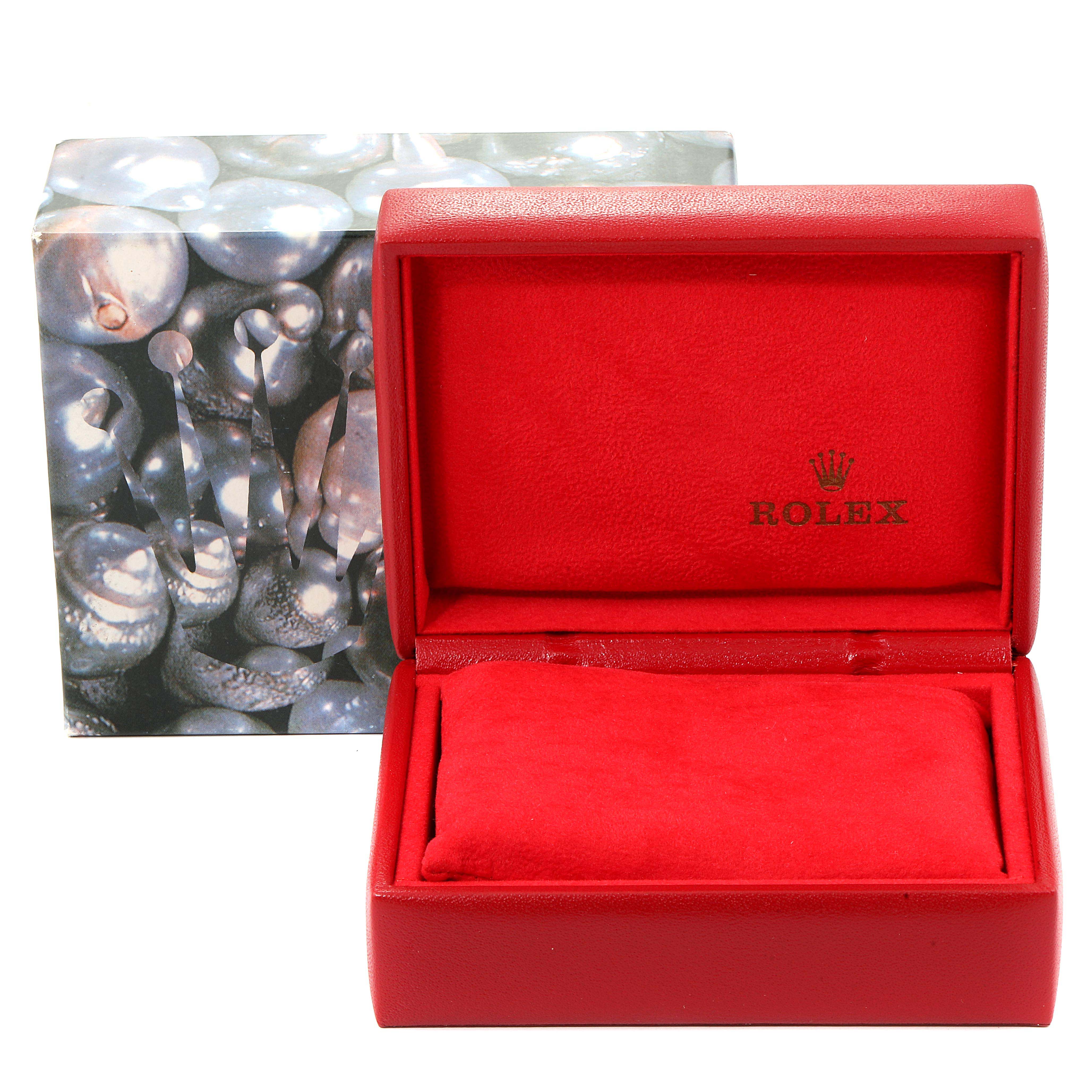 This image shows an open red Rolex watch box, designed for an Oyster Perpetual model, with a pillow inside and the Rolex logo.