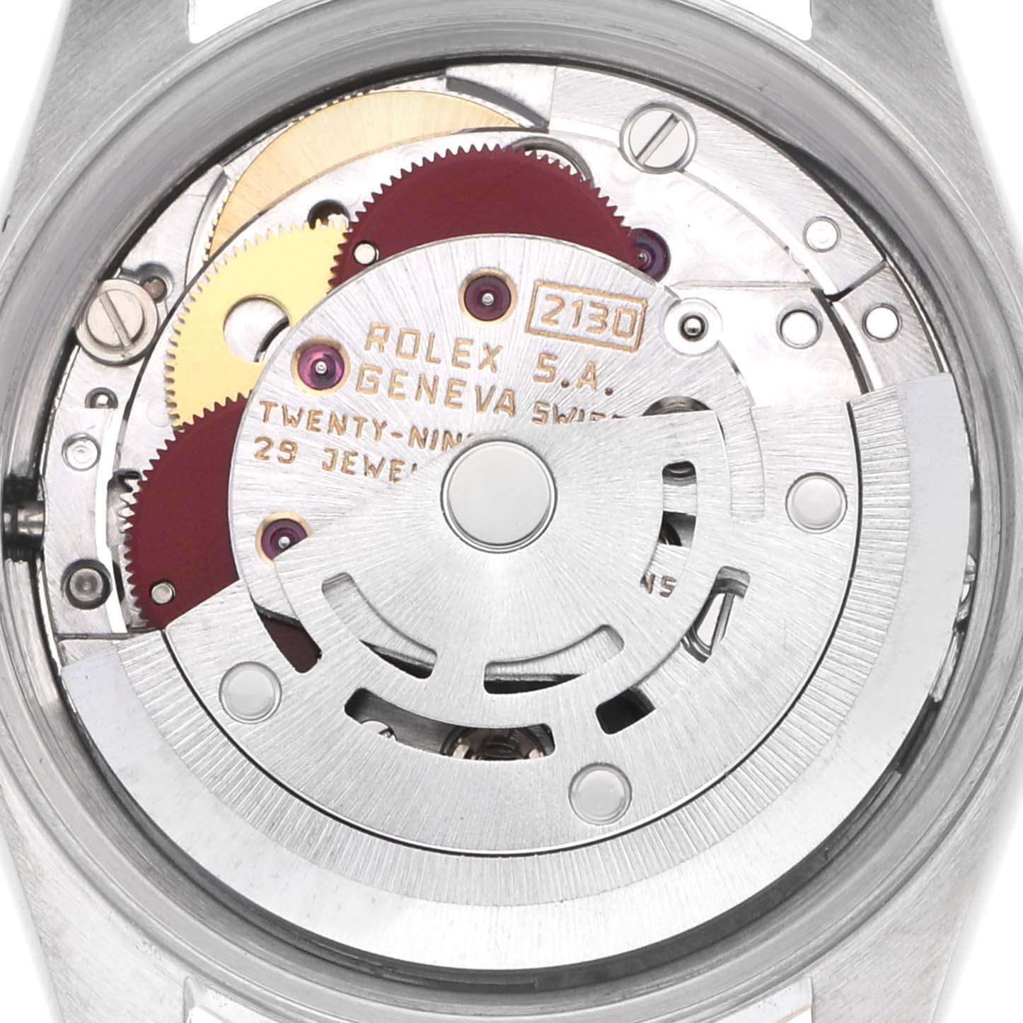 The image shows the movement of a Rolex Oyster Perpetual 67193 Women
s Steel and Gold (two tone) Champagne Dial 67193 Women
s Steel and Gold (two tone) Champagne Dial watch from a rear angle, highlighting its internal mechanical components.