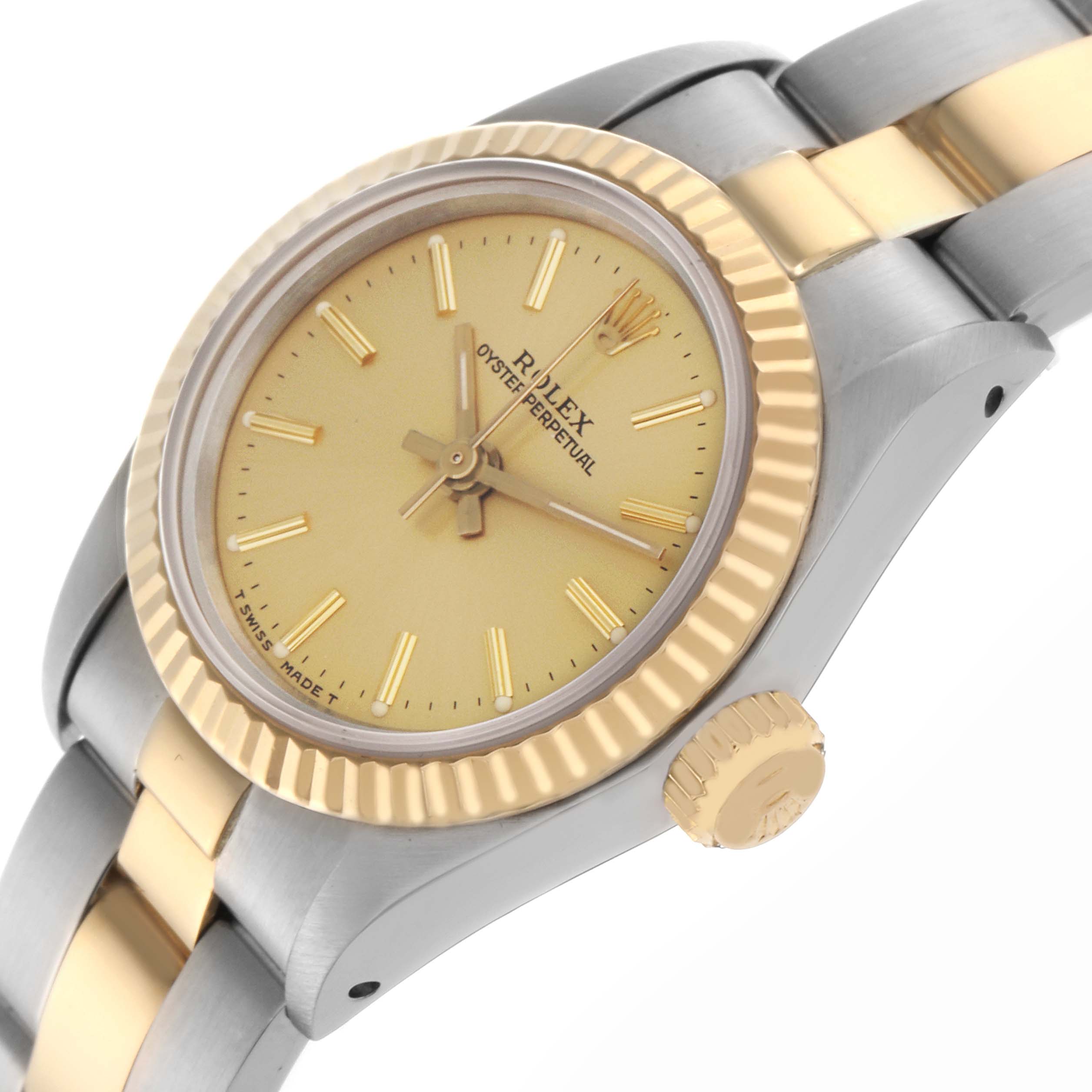 The Rolex Oyster Perpetual 67193 Women
s Steel and Gold (two tone) Champagne Dial 67193 Women
s Steel and Gold (two tone) Champagne Dial watch is shown at an angled side view, highlighting its gold and silver bracelet, bezel, and crown.