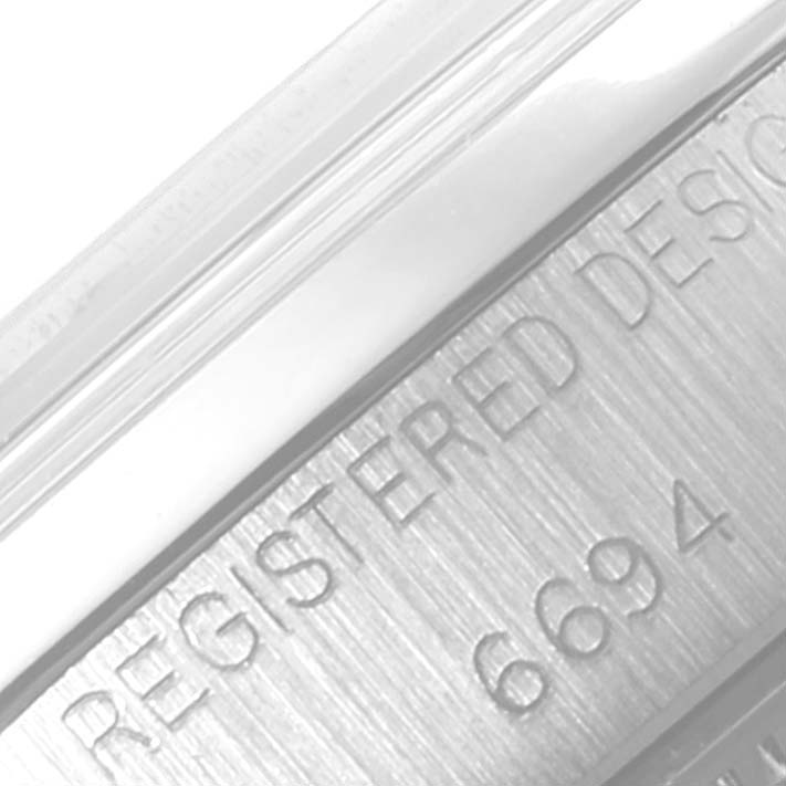 This close-up image shows the engraved "REGISTERED DESIGN" and model number "6694" on the caseback of a Rolex Date 6694 Men's Stainless Steel Silver Dial 6694 Men's Stainless Steel Silver Dial model.