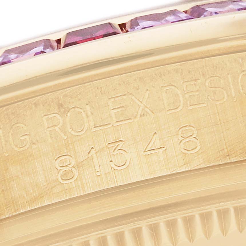 This close-up angle of the Rolex Pearlmaster 81348SARO Women's Yellow Gold Champagne Dial 81348SARO Women's Yellow Gold Champagne Dial watch shows its bezel with embedded gemstones and engraved serial number.