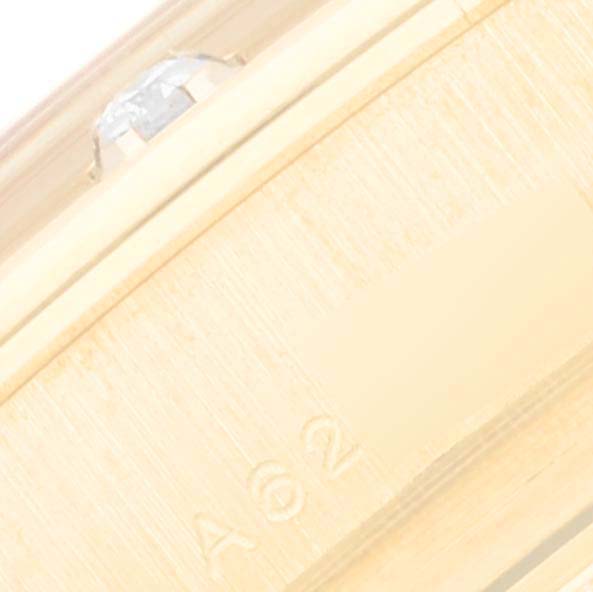 This image shows a close-up of the clasp or bracelet part of a Rolex Pearlmaster 80318 Women's Yellow Gold Mother of Pearl Dial 80318 Women's Yellow Gold Mother of Pearl Dial watch, focusing on etched markings and a partial diamond.