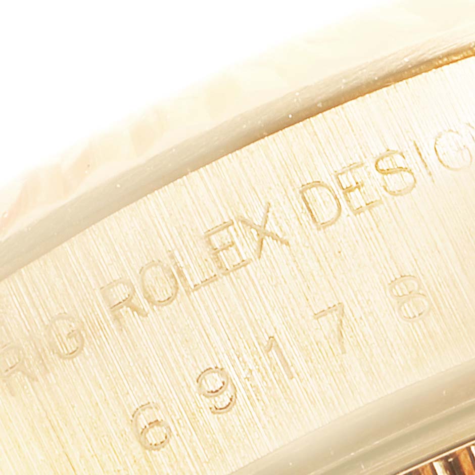 This close-up image shows the engraved text on the side of the Rolex President 69178 Women
s Yellow Gold Champagne Dial 69178 Women
s Yellow Gold Champagne Dial model watch.