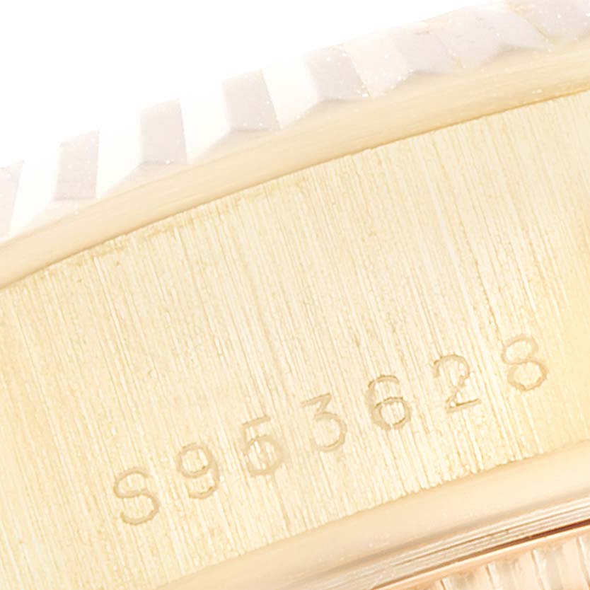 This close-up image of the Rolex President 69178 Women
s Yellow Gold Champagne Dial 69178 Women
s Yellow Gold Champagne Dial watch displays a detailed view of its bezel and the serial number.