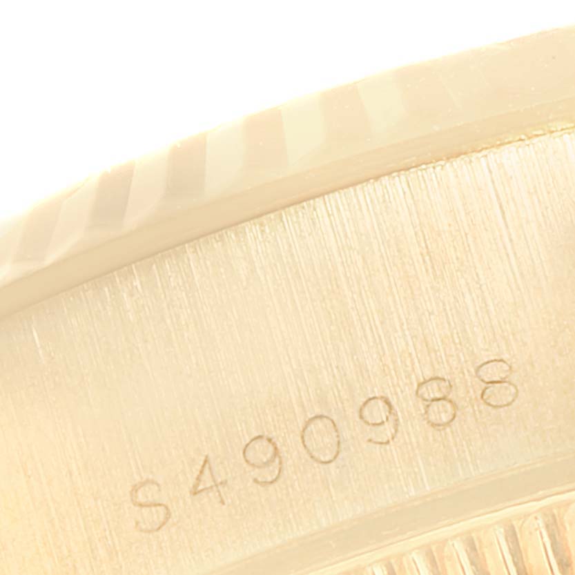 This close-up image shows the serial number engraving on the side of the case of a Rolex President 69178 Women
s Yellow Gold Champagne Dial 69178 Women
s Yellow Gold Champagne Dial model watch.