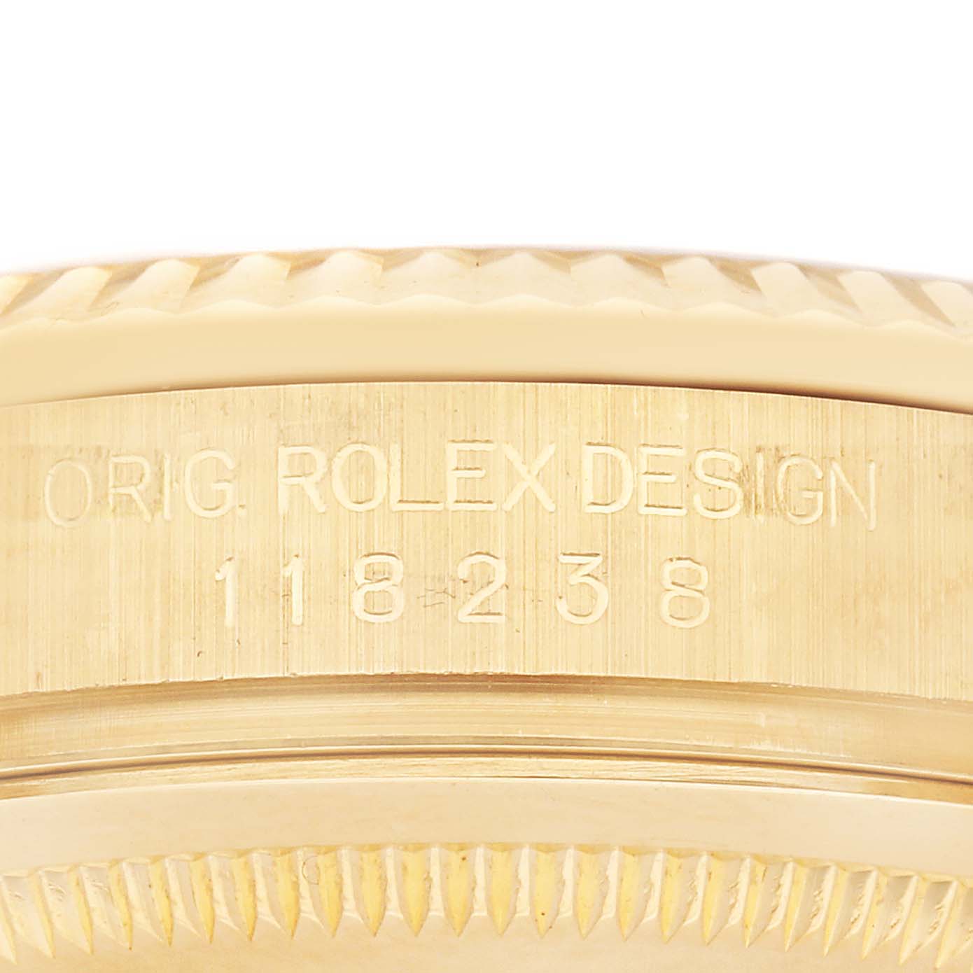 The image shows a close-up of the Rolex President 118238 Men
s Yellow Gold White Dial 118238 Men
s Yellow Gold White Dial model
s side, highlighting the engraved model number and part of the fluted bezel.