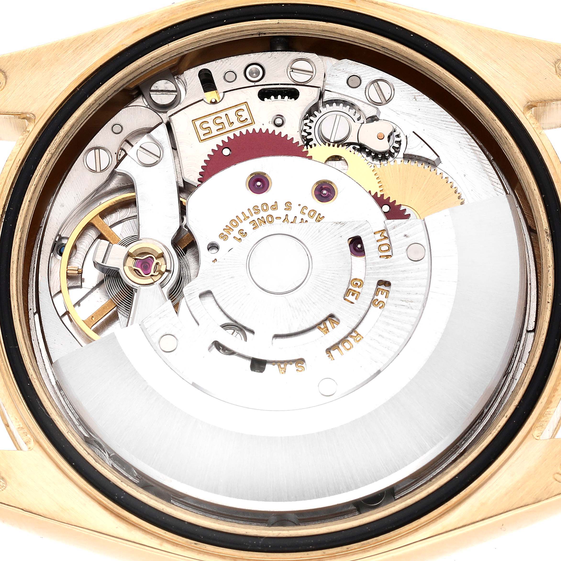 The image shows the internal movement of a Rolex President 118238 Men
s Yellow Gold White Dial 118238 Men
s Yellow Gold White Dial watch from the back, highlighting gears and components.