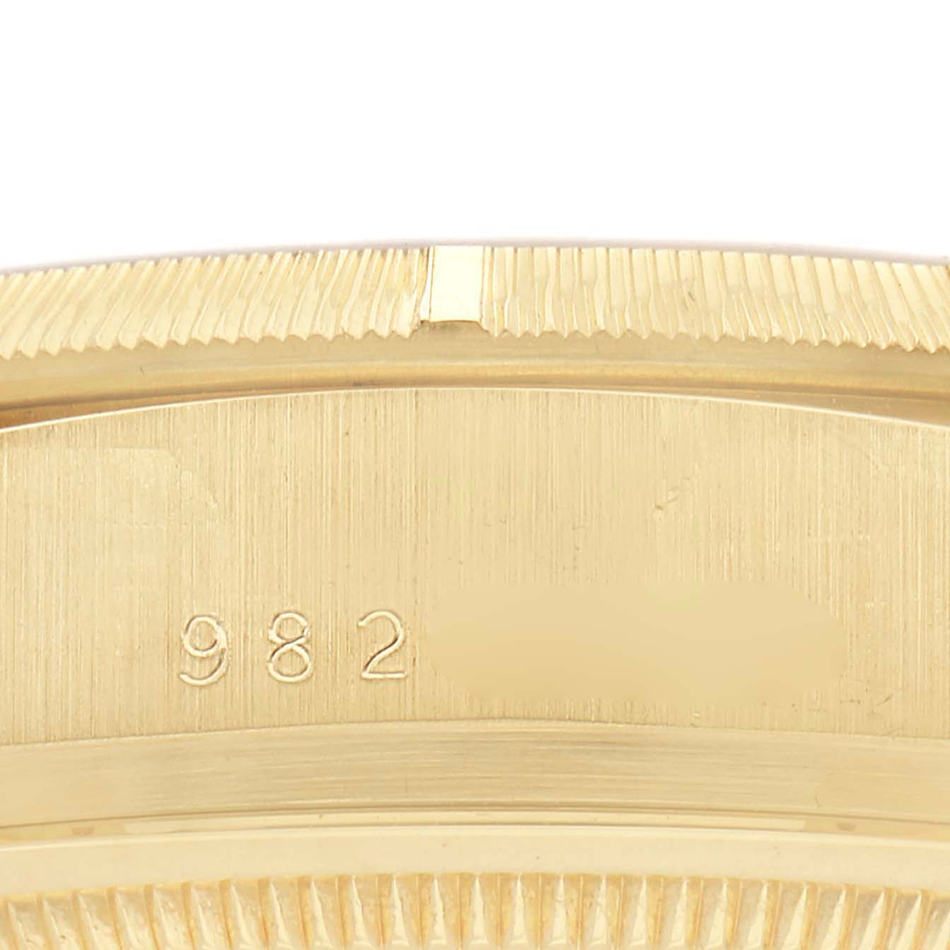 The image shows a close-up of the side of a Rolex President 18078 Men
s Yellow Gold Champagne Dial 18078 Men
s Yellow Gold Champagne Dial model watch, focusing on the bezel and engravings.