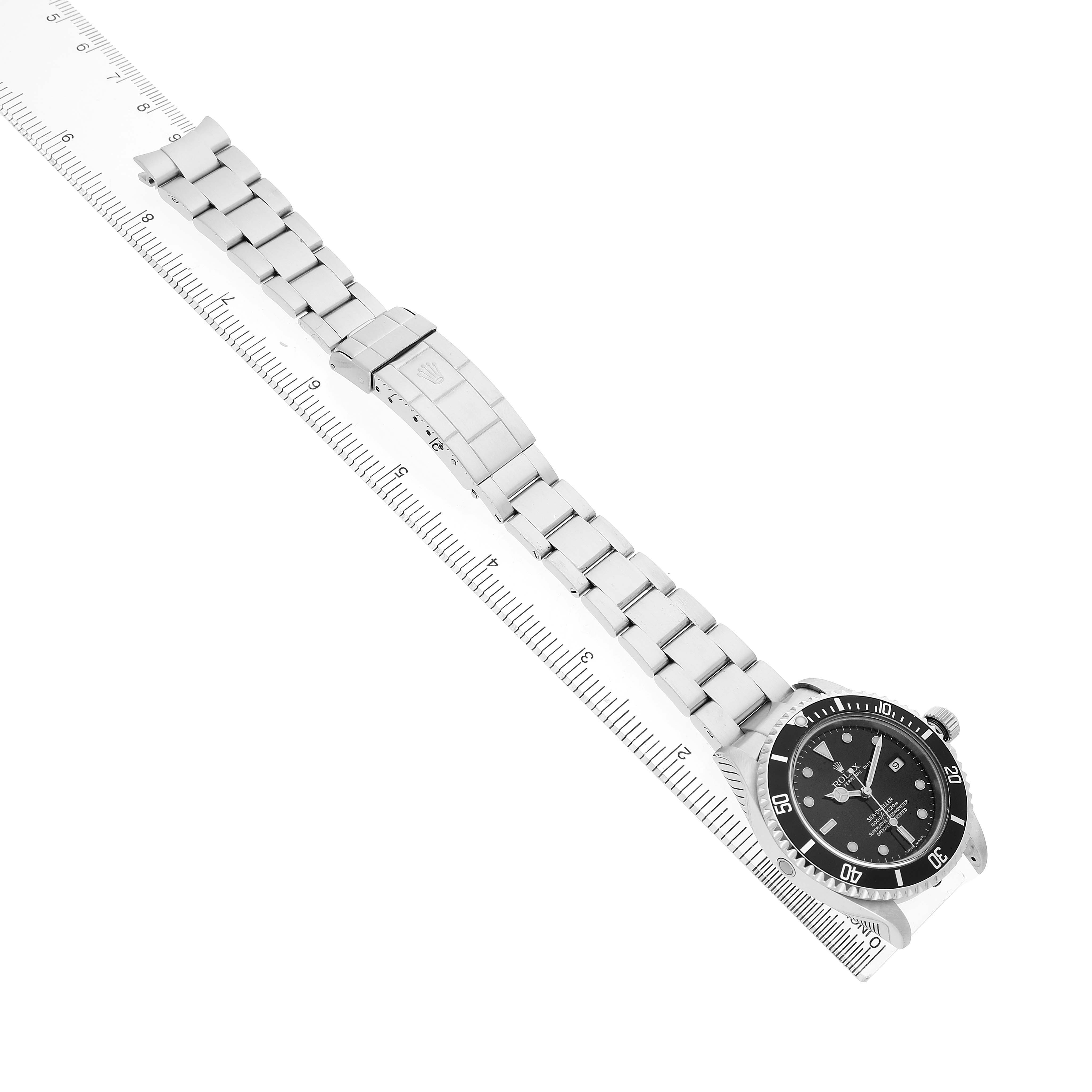 The image shows the Rolex Sea-Dweller 16600 Men's Stainless Steel Black Dial watch diagonally, displaying its full bracelet and clasp alongside a ruler for scale.