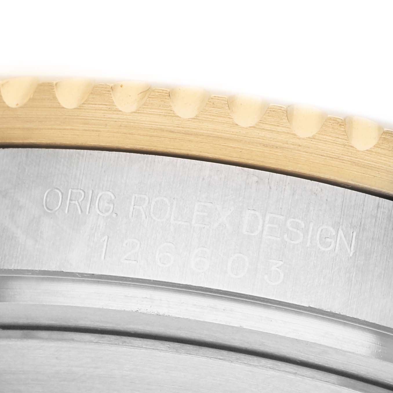 The image shows a close-up of the bezel and case side of a Rolex Sea-Dweller 126603 Men's Steel and Gold (two tone) Black Dial, highlighting engraving details.