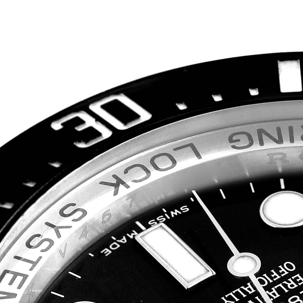 This close-up image focuses on the bezel and part of the dial of the Rolex Sea-Dweller 116660 Men
s Stainless Steel Black Dial 116660 Men
s Stainless Steel Black Dial watch.
