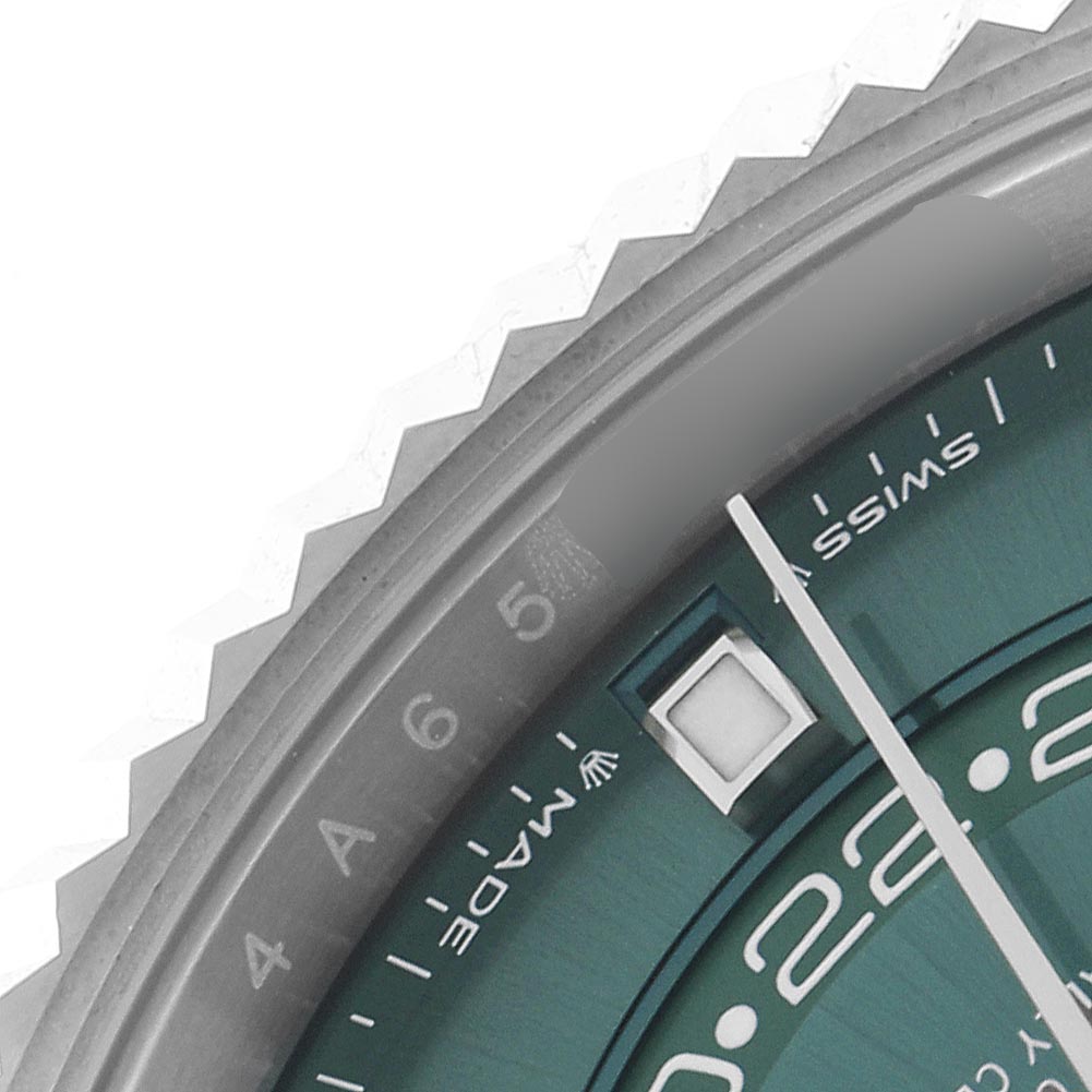 The image shows a close-up of the Rolex Sky-Dweller 336934 Men's Stainless Steel Green Dial's green dial, fluted bezel, and part of the minute hand.