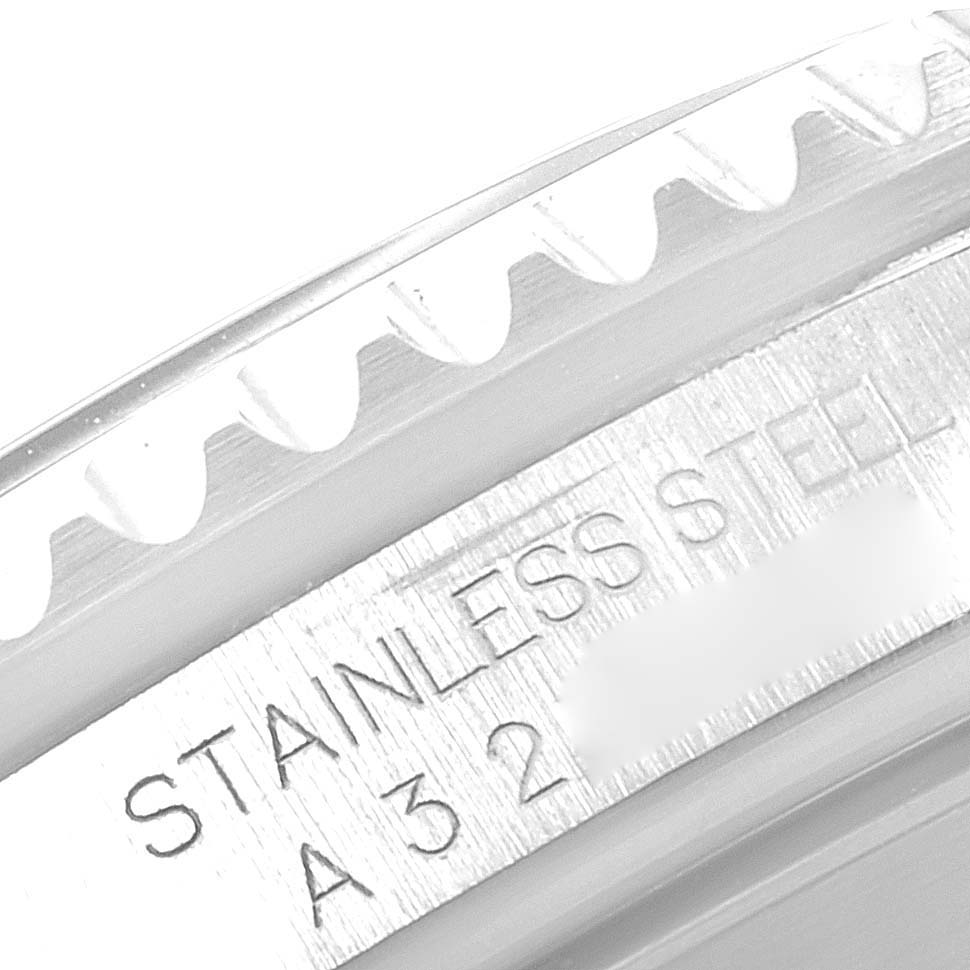 The image shows a close-up of the bezel and part of the outer ring of a Rolex Submariner 16610 Men
s Stainless Steel Black Dial 16610 Men
s Stainless Steel Black Dial watch with "STAINLESS STEEL" engraved.