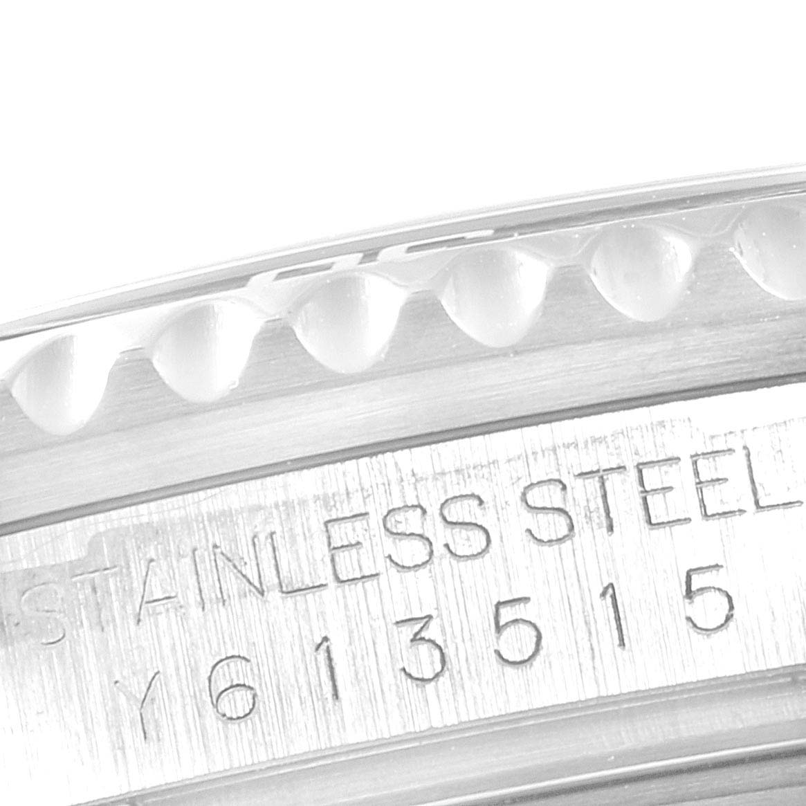 The image shows a close-up of the bezel and engraved serial number of a Rolex Submariner 16610 Men's Stainless Steel Black Dial 16610 Men's Stainless Steel Black Dial.