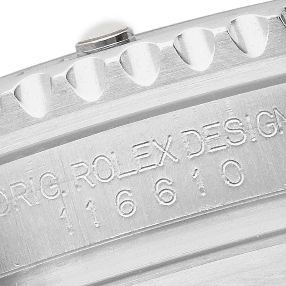 The image shows a close-up of the Rolex Submariner 116610 Men's Stainless Steel Black Dial's engraved inner bezel with model number and the edge of the toothed bezel.