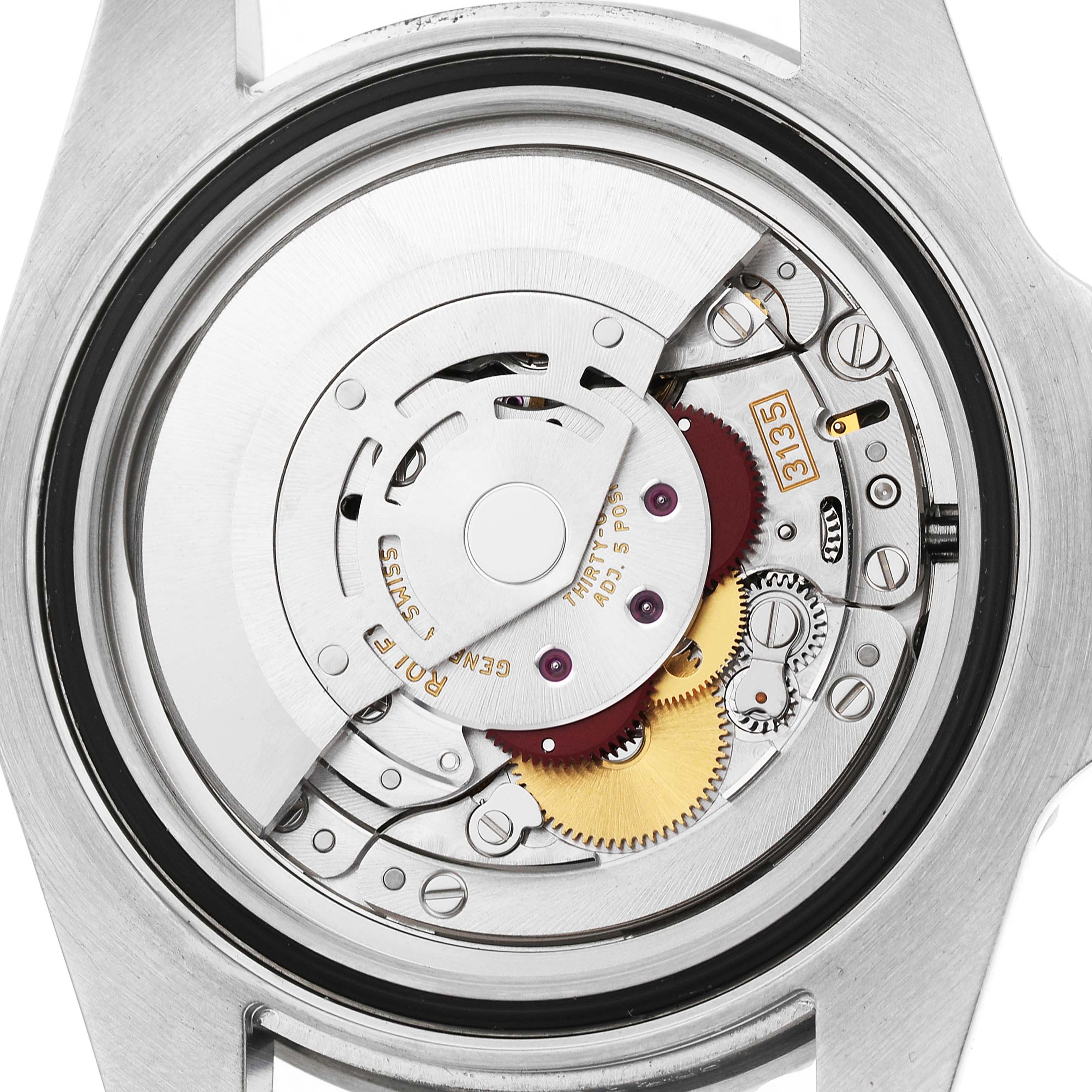 The image shows the movement of a Rolex Submariner 116610 Men's Stainless Steel Black Dial watch from a back angle, highlighting gears and the rotor.