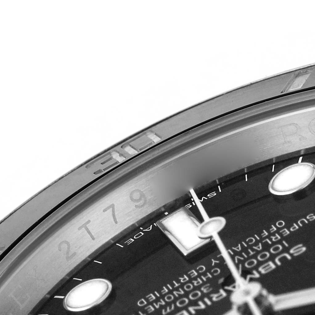 The image shows a close-up angle of the Rolex Submariner 116610 Men's Stainless Steel Black Dial's dial, highlighting the bezel and part of the watch face with numeral markings.