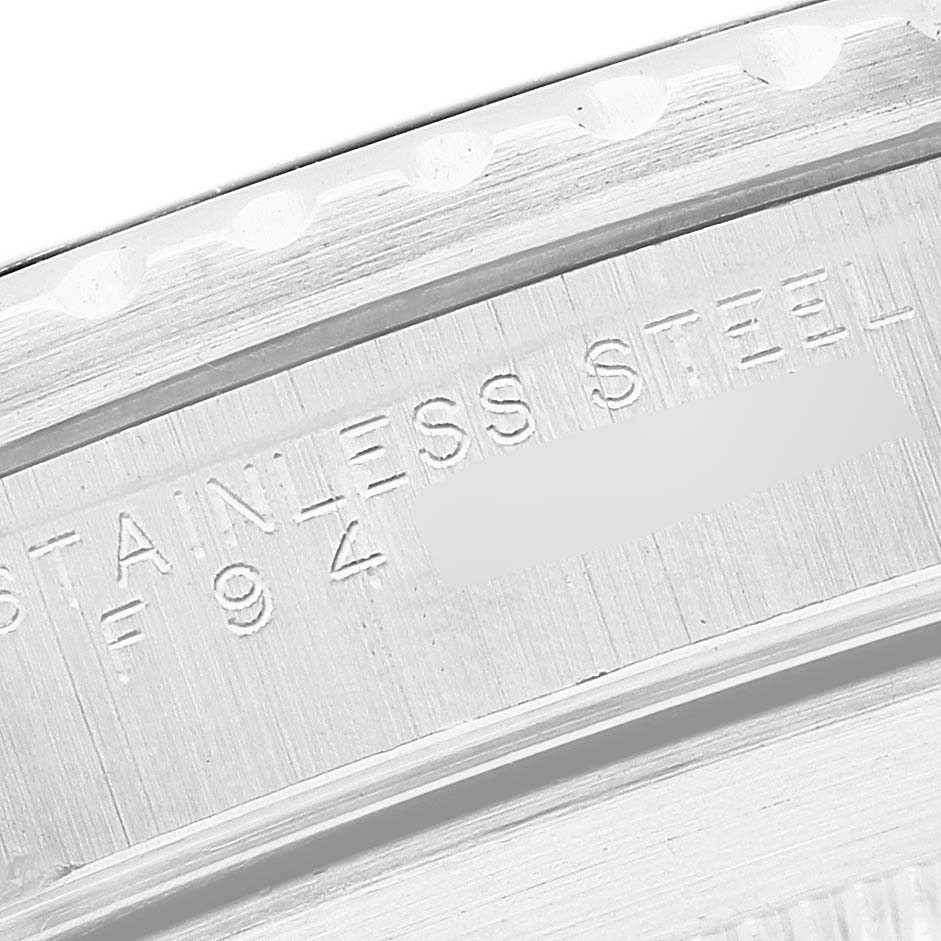 The image shows a close-up of the stainless steel case back edge and engravings of the Rolex Submariner 14060 Men's Stainless Steel Black Dial.