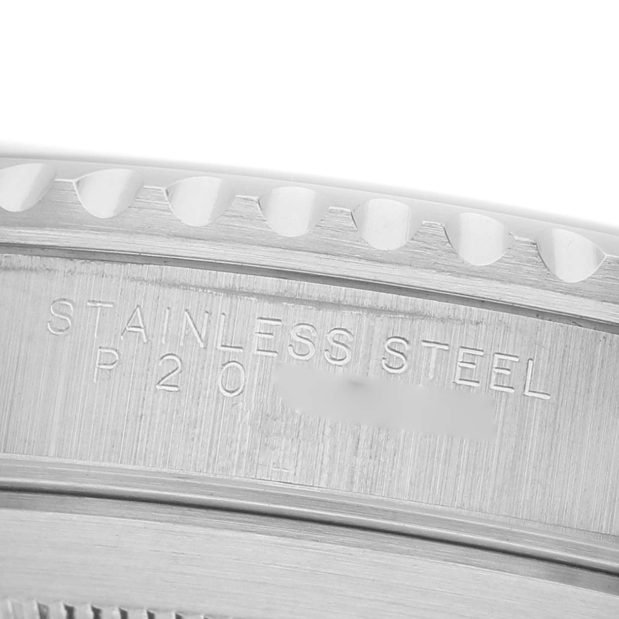 The image shows a close-up of the engraved stainless steel part of a Rolex Submariner 14060 Men's Stainless Steel Black Dial's bezel.
