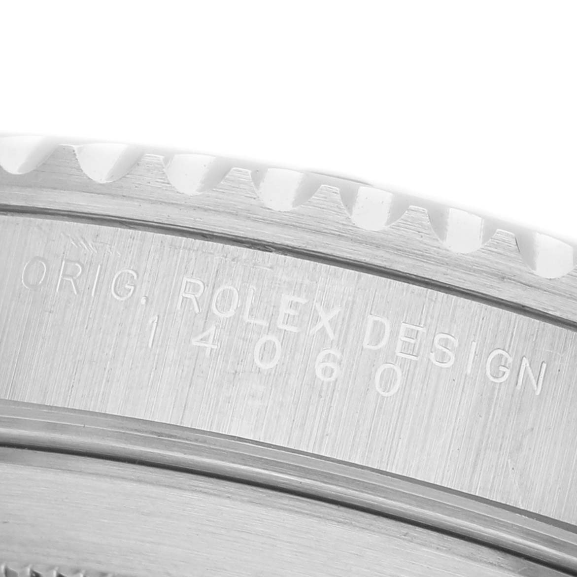 The image shows an engraved side view of the bezel on a Rolex Submariner 14060 Men's Stainless Steel Black Dial, focusing on its design details.