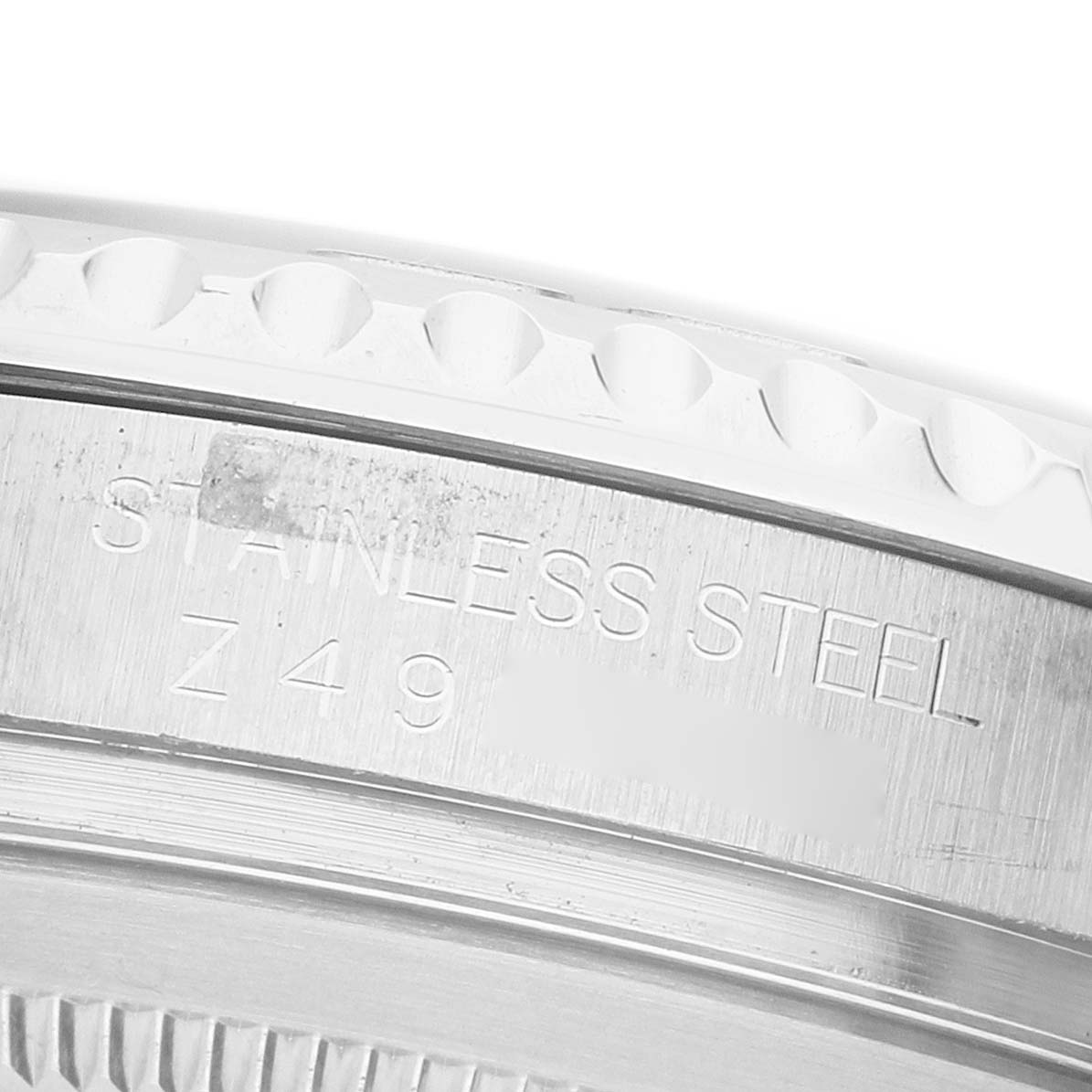 The image shows a close-up of the Rolex Yacht-Master 16622 Men's Stainless Steel Silver Dial's stainless steel case with engravings visible.