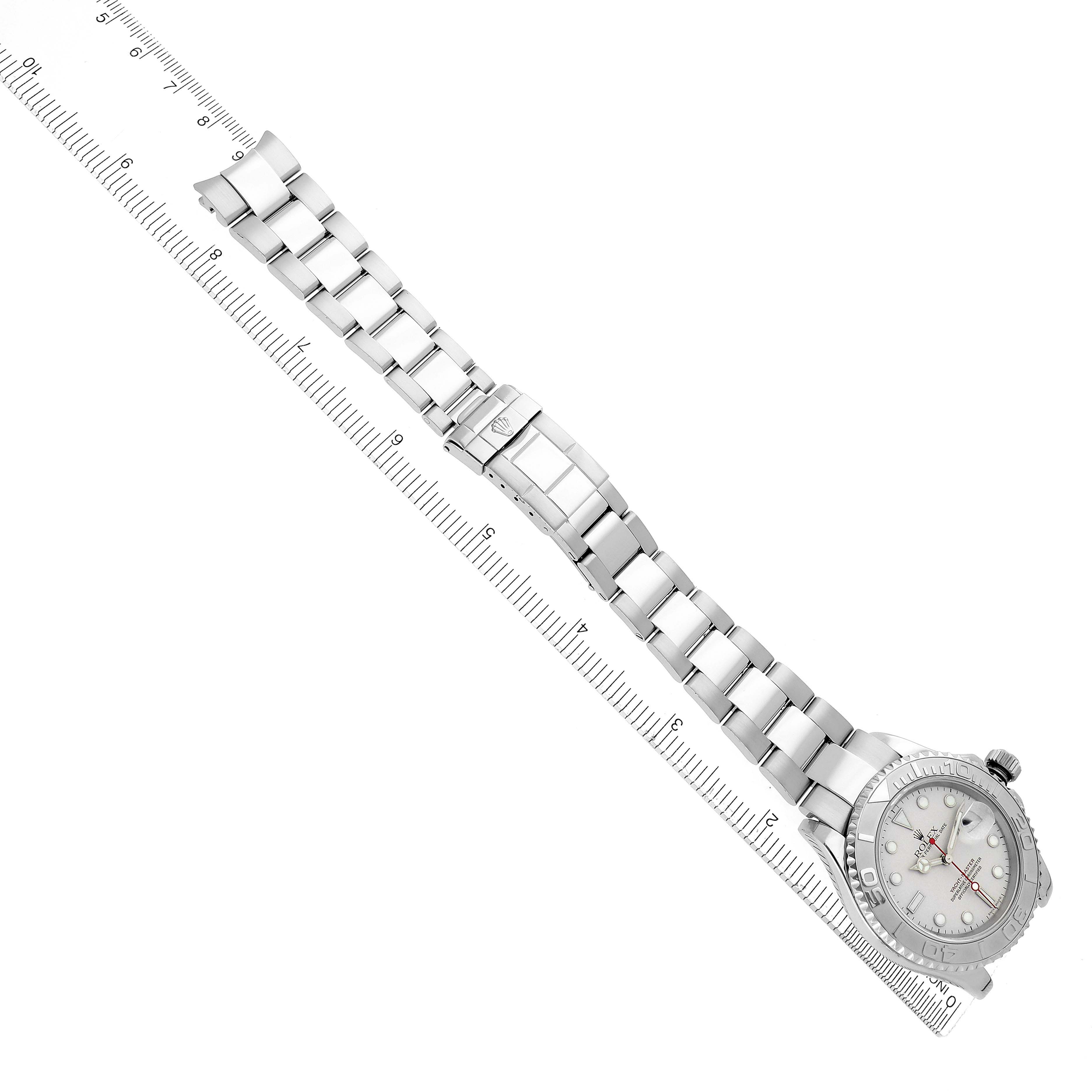 The image shows a Rolex Yacht-Master 16622 Men
s Stainless Steel Silver Dial 16622 Men
s Stainless Steel Silver Dial watch laid flat with the full bracelet and clasp visible, beside a ruler for scale.