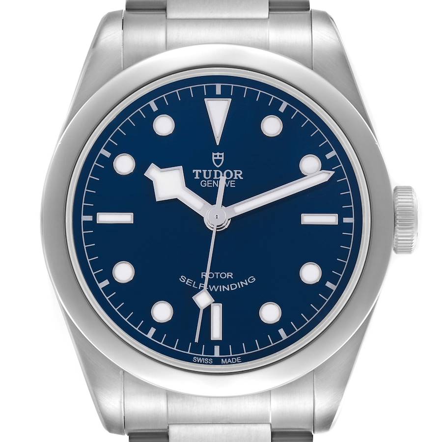 The Tudor Heritage Black Bay watch is shown from a front angle, displaying the dial, bezel, and part of the bracelet.