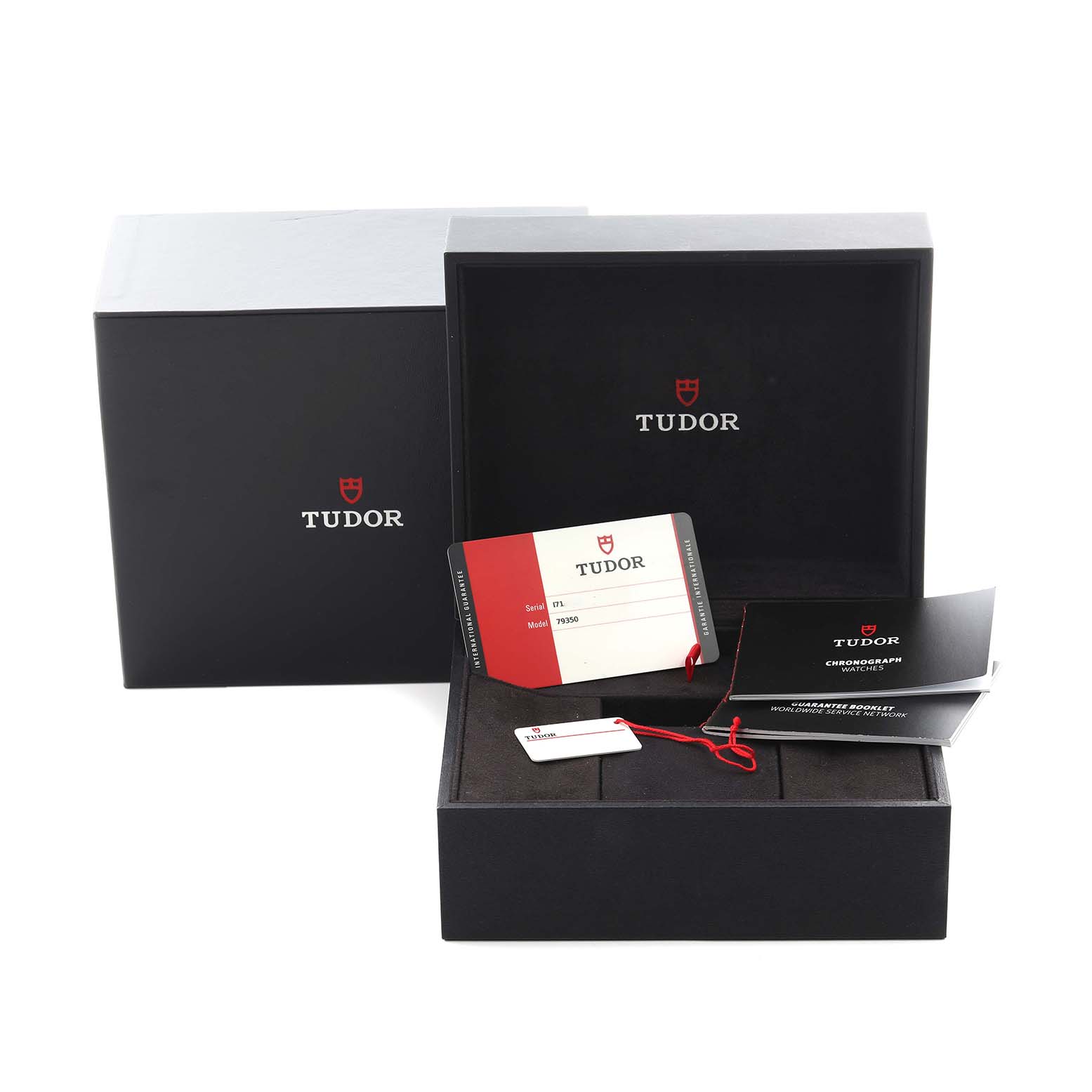 The image shows a Tudor Heritage Black Bay 79350 Men
s Stainless Steel Black Dial 79350 Men
s Stainless Steel Black Dial watch box with warranty cards and booklets, photographed from a front angle.