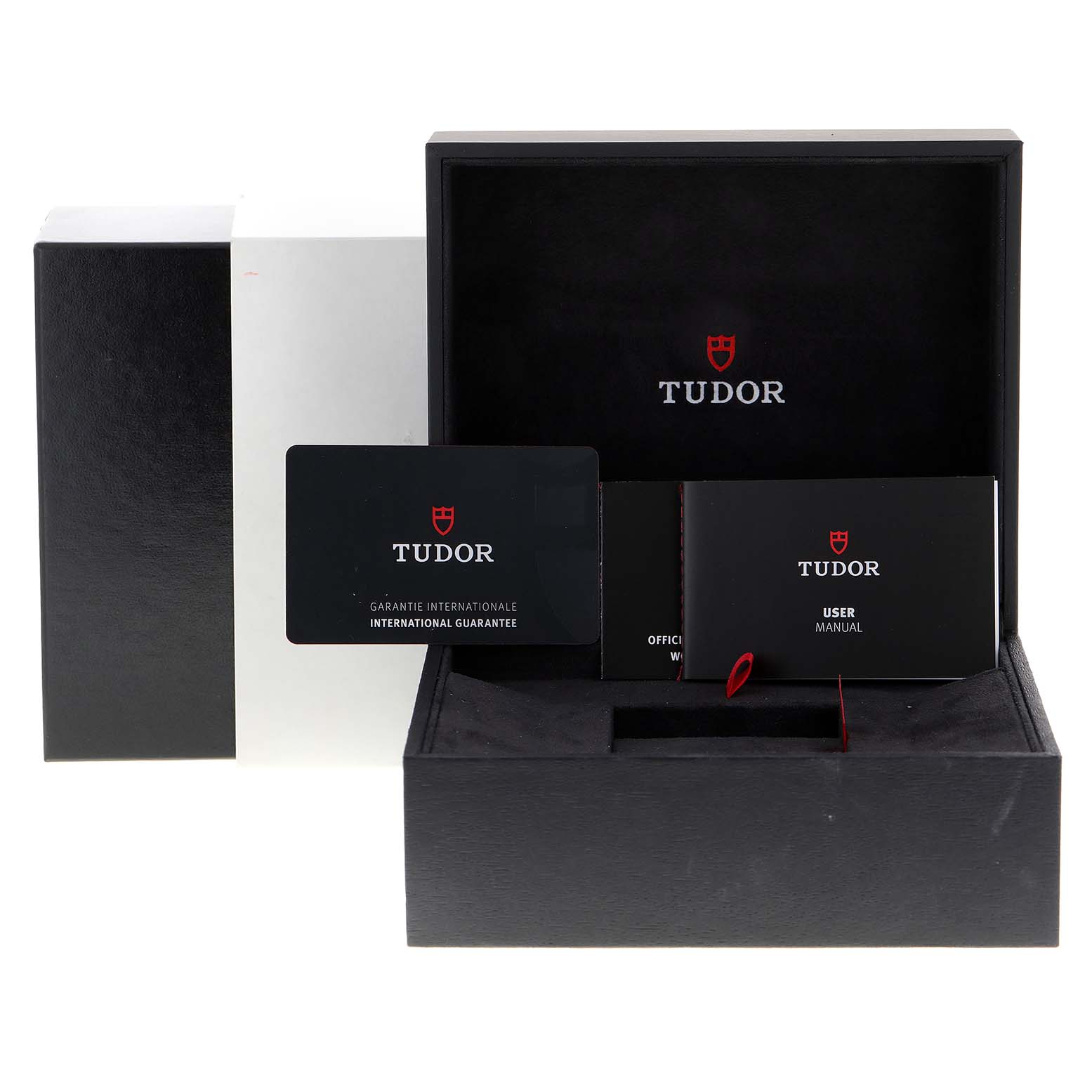 The image shows an open Tudor Heritage Black Bay 79830RB Men
s Stainless Steel Black Dial 79830RB Men
s Stainless Steel Black Dial watch box with warranty card, user manual, and other documents visible from the front angle.