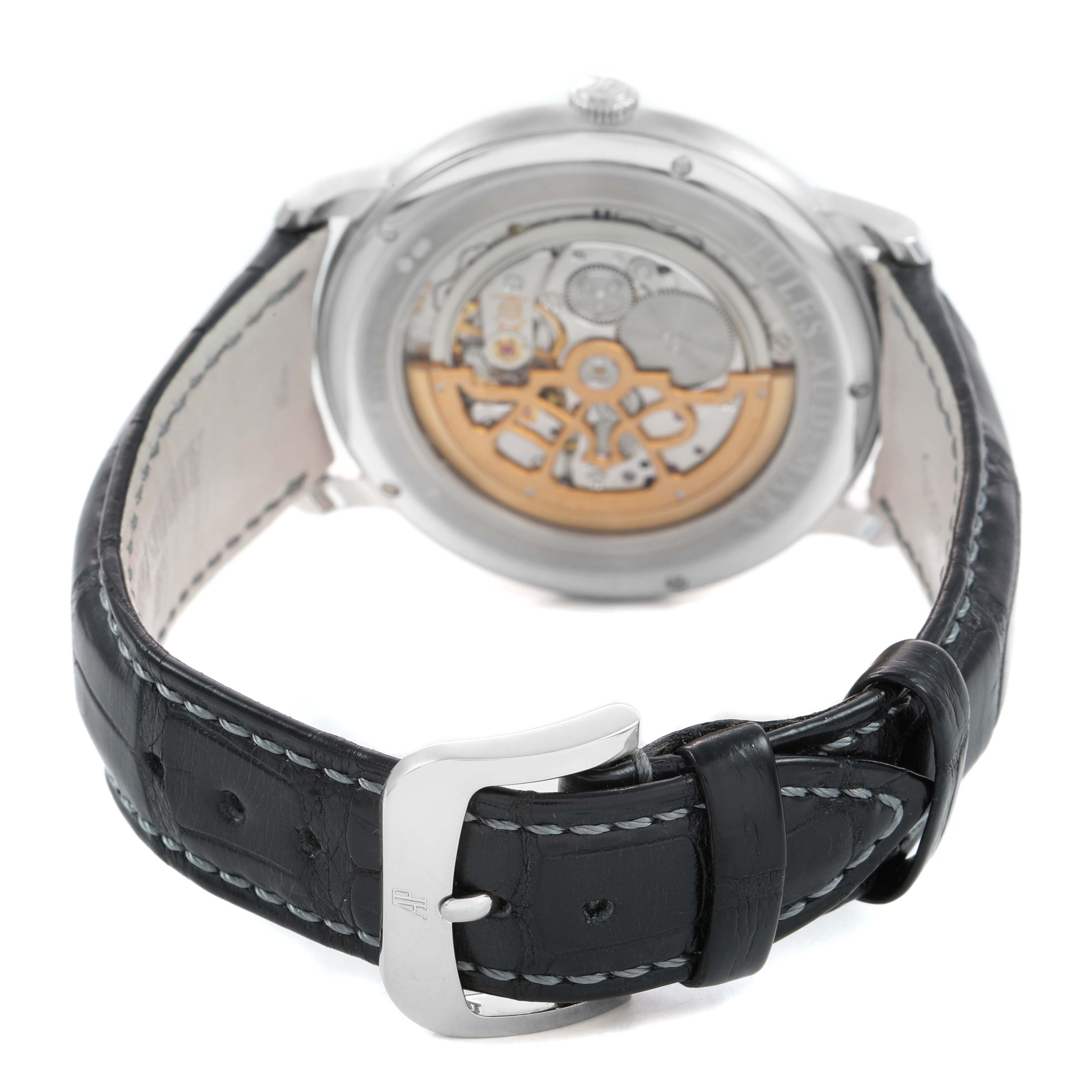 The image shows the back of the Audemars Piguet Jules 15180BC Men's White Gold Silver Dial watch, highlighting the movement through a transparent case back and its leather strap.
