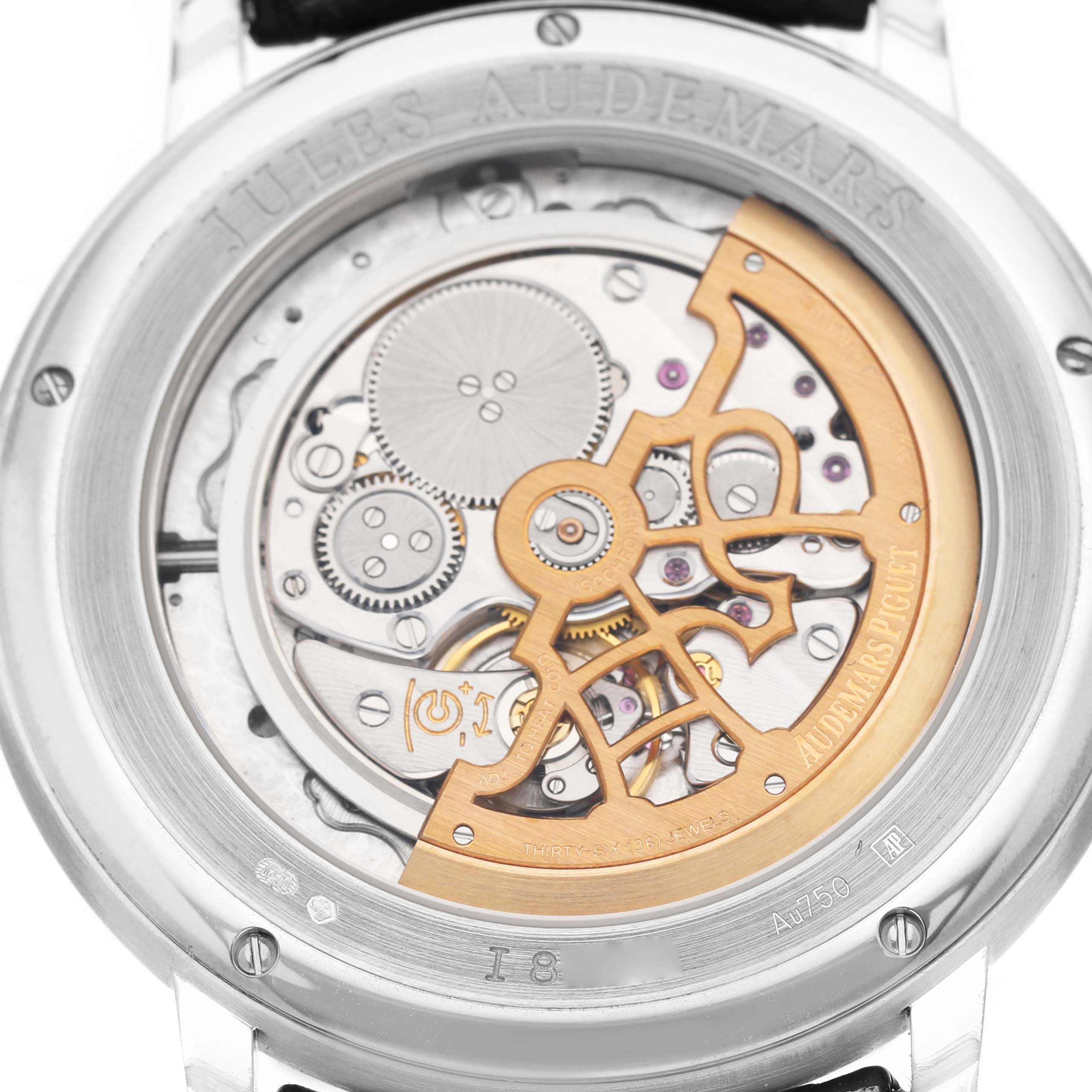 The image shows the back of a Jules model watch by Audemars Piguet, highlighting its intricate movement and rotor.