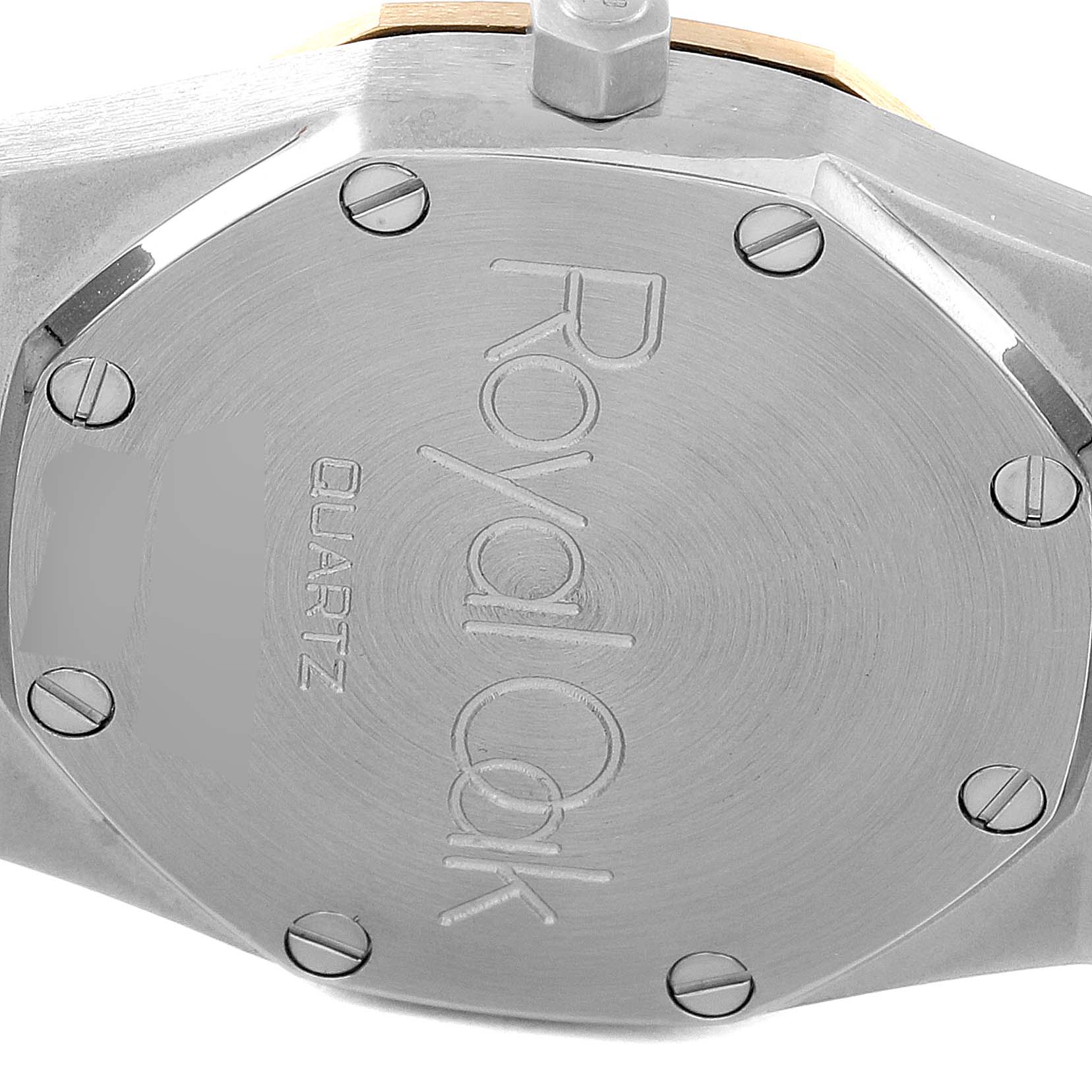 The image shows the case back of the Royal Oak model by Audemars Piguet, highlighting the engravings and screws.