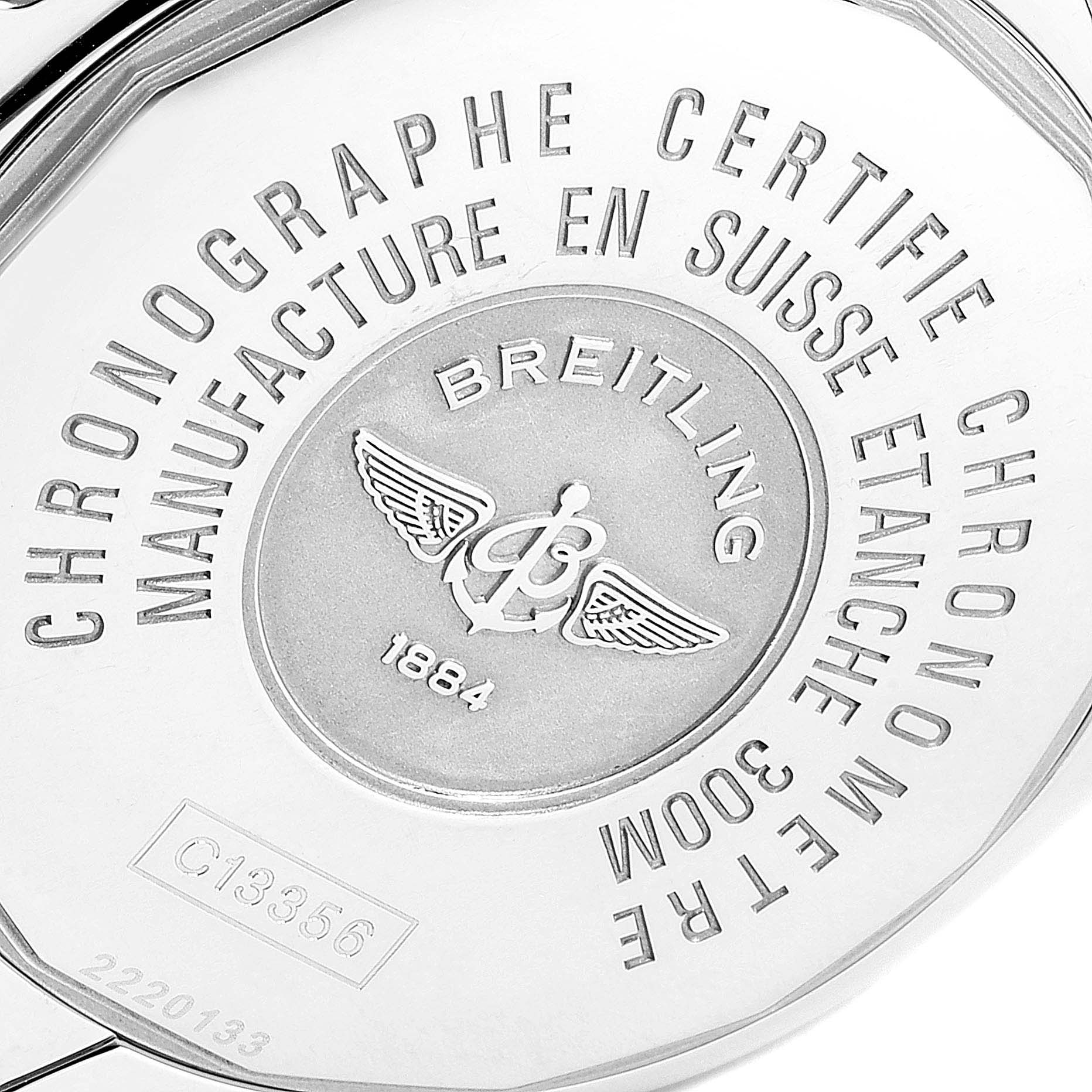 The image shows the case back of a Breitling Chronomat C13356 Men's Steel and Gold (two tone) White Dial C13356 Men's Steel and Gold (two tone) White Dial watch, highlighting inscriptions and the Breitling logo.