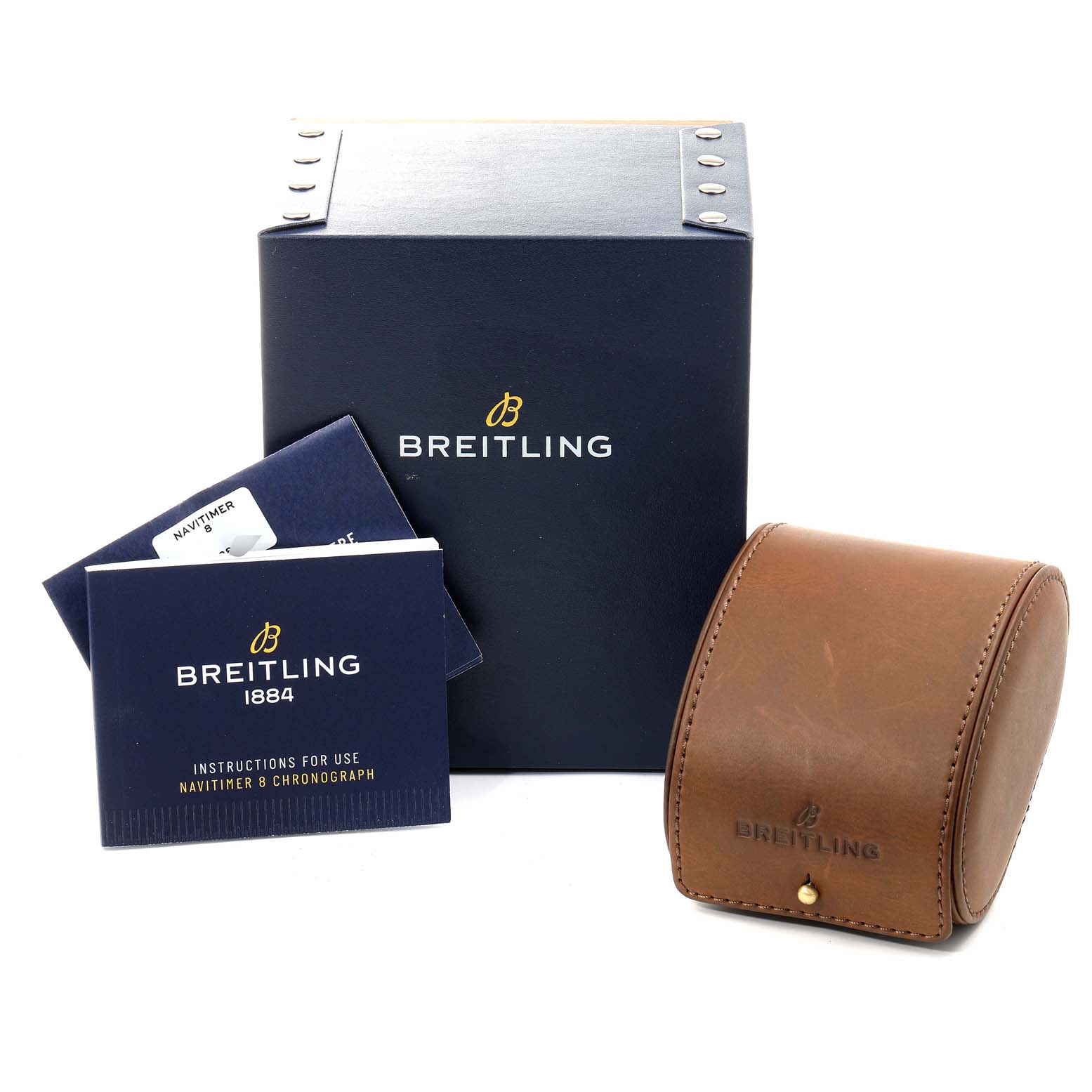 The image shows a Breitling Navitimer M13314101B1X1 Men
s Stainless Steel Black Dial M13314101B1X1 Men
s Stainless Steel Black Dial watch box, instruction booklets, and a leather travel case from a front angle.