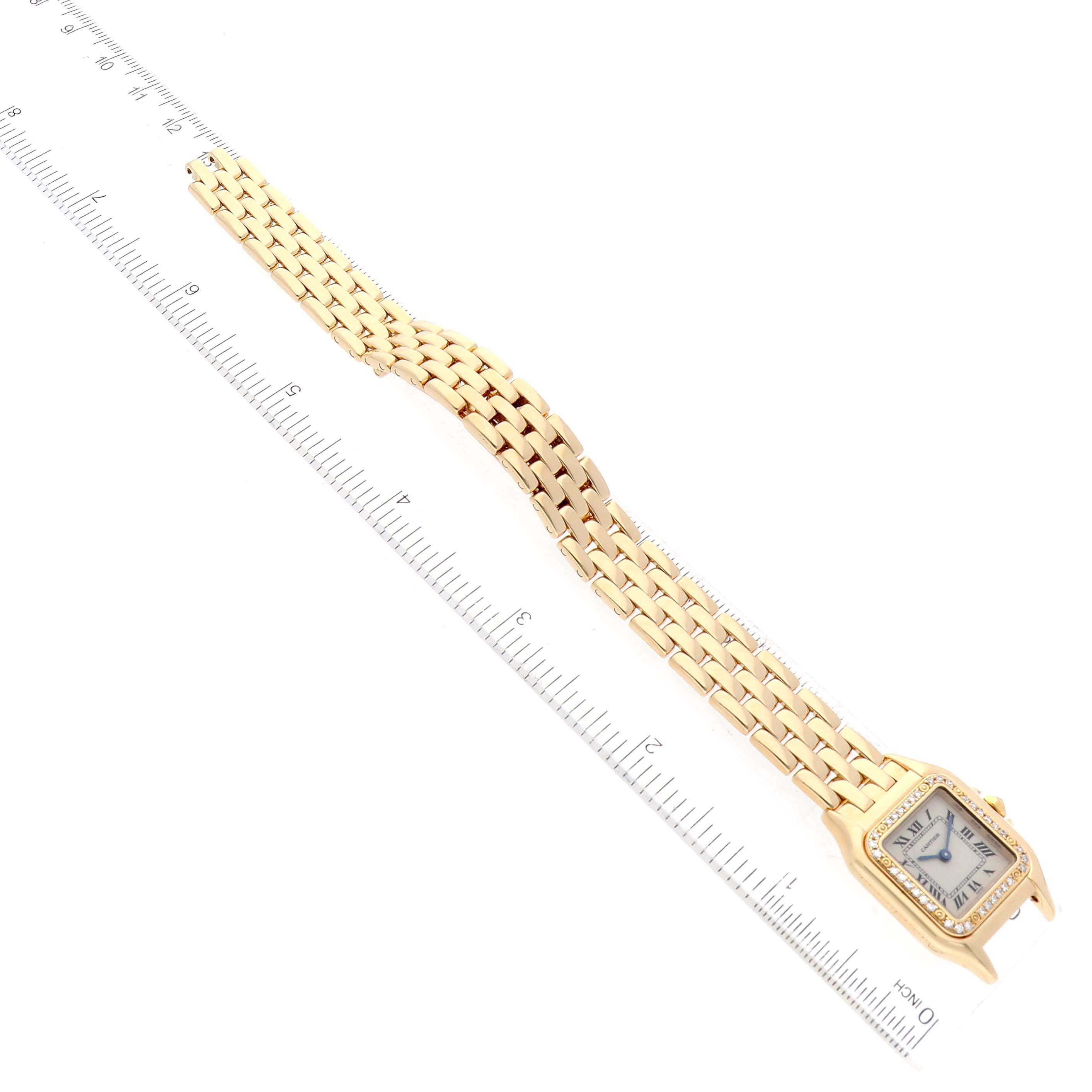 The image shows the face and entire bracelet of a Cartier Panthere WF3070B9 Women's Yellow Gold Silver Dial WF3070B9 Women's Yellow Gold Silver Dial watch at an overhead angle, placed alongside a measuring ruler.