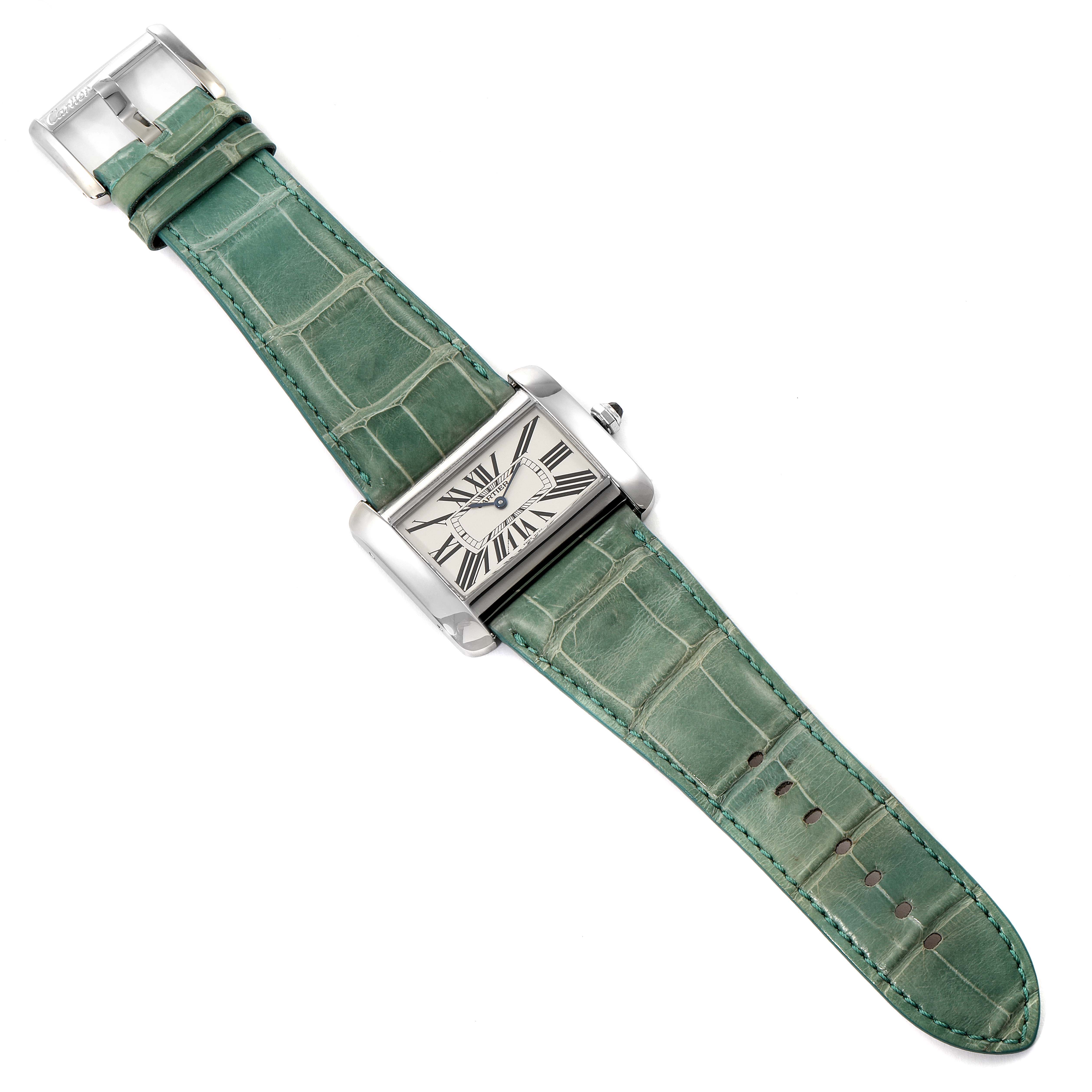 This Cartier Tank Divan W6300755 Men
s Stainless Steel Silver Dial W6300755 Men
s Stainless Steel Silver Dial model watch is shown from a top-down angle, displaying the face, case, and green leather strap.