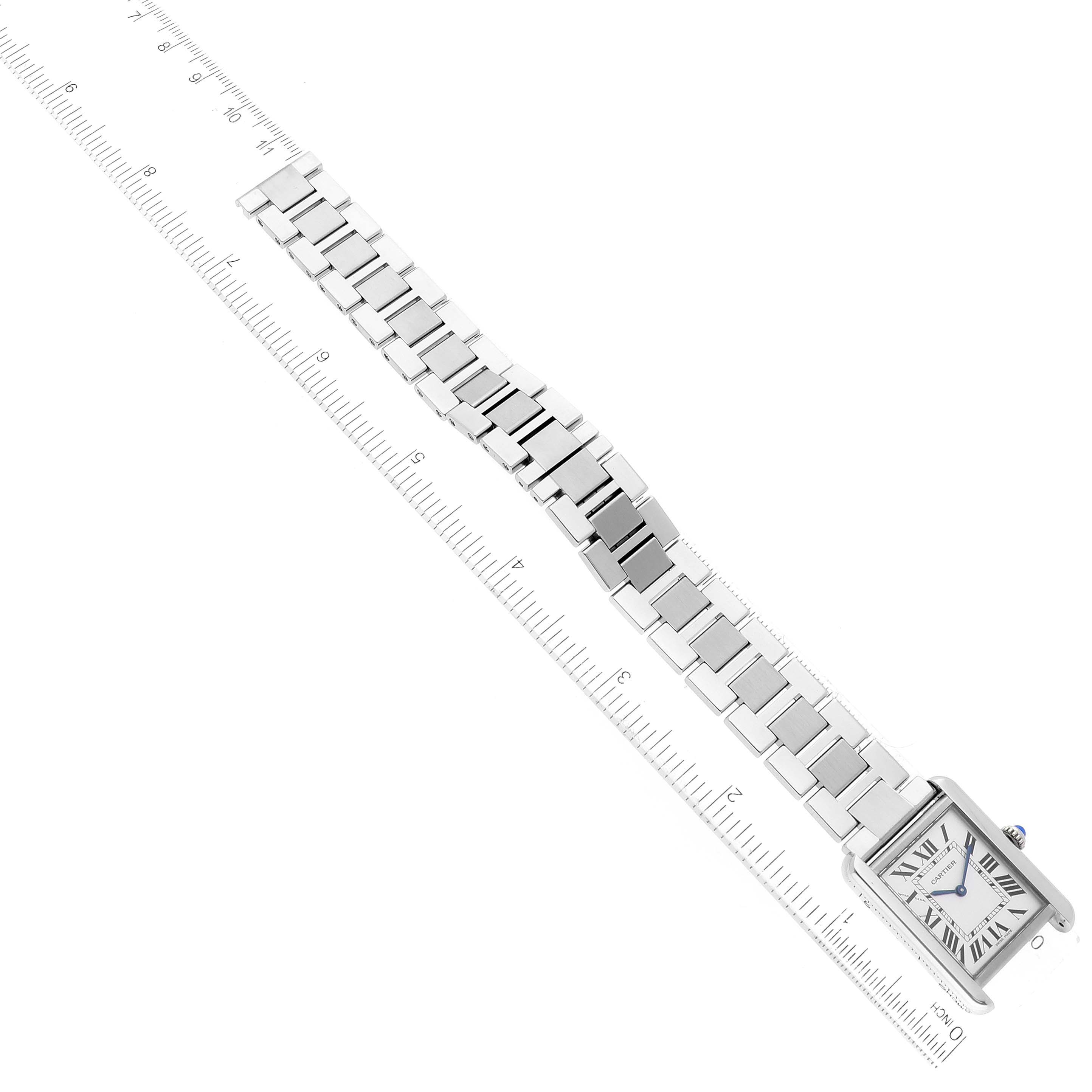 This image shows a top-down view of the Cartier Tank Solo W5200013 Women's Stainless Steel Silver Dial W5200013 Women's Stainless Steel Silver Dial watch, including its face and metal bracelet, placed beside a ruler for scale.