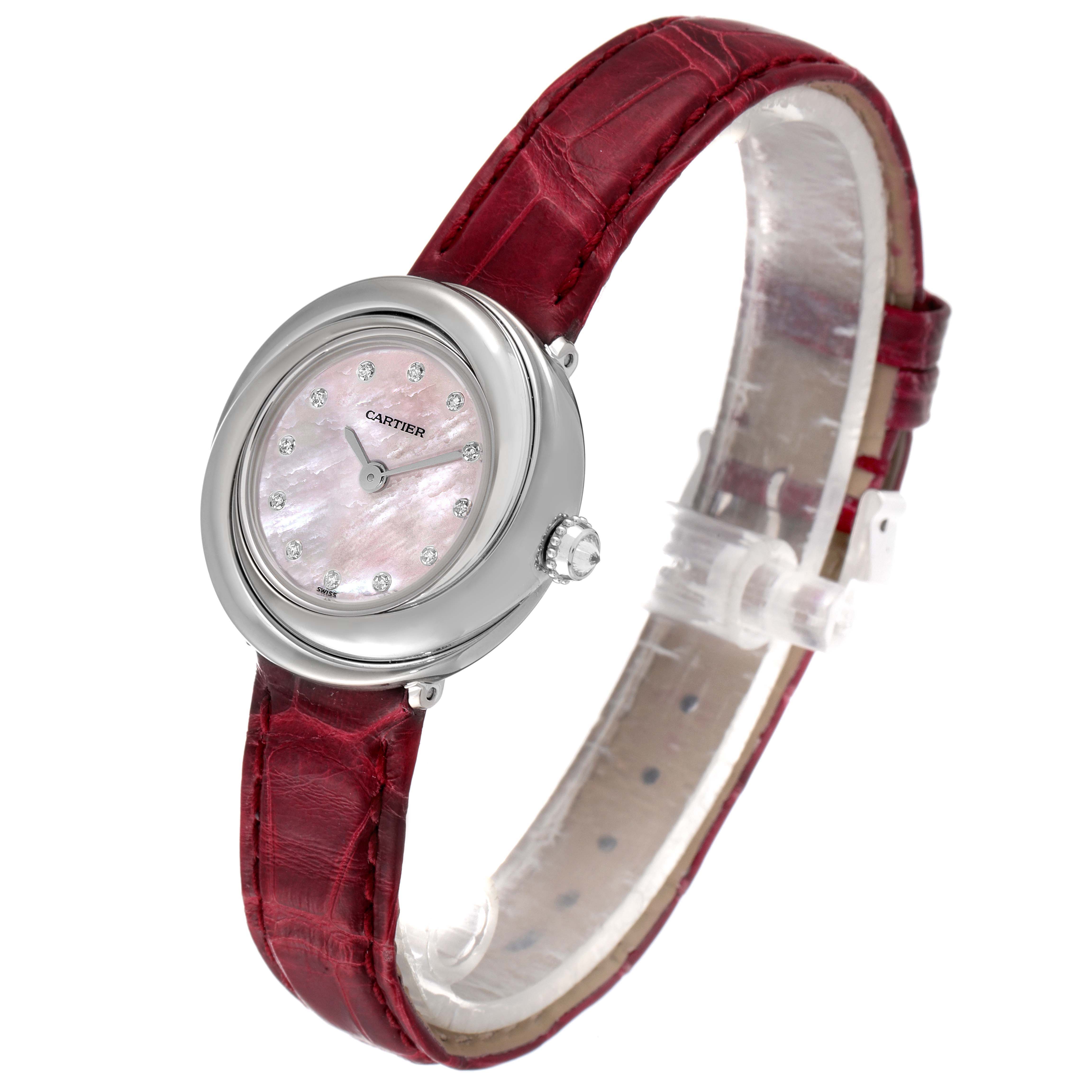 The Cartier Trinity WG200846 Women's White Gold Mother of Pearl Dial watch is shown at a three-quarter angle, displaying the face, bezel, and red strap.