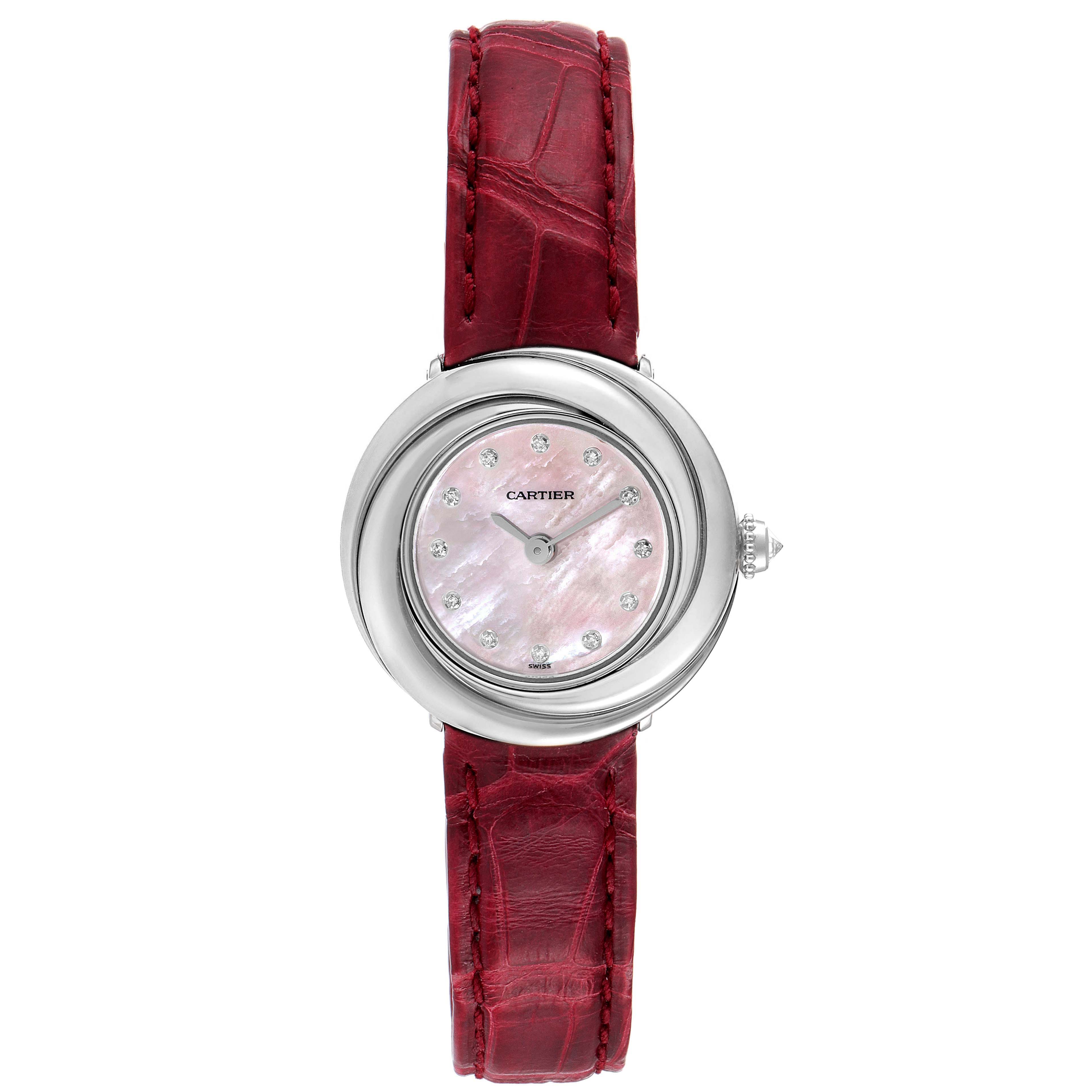 The Cartier Trinity WG200846 Women's White Gold Mother of Pearl Dial watch is shown from a top view, highlighting its round face, diamond markers, silver casing, and red leather strap.