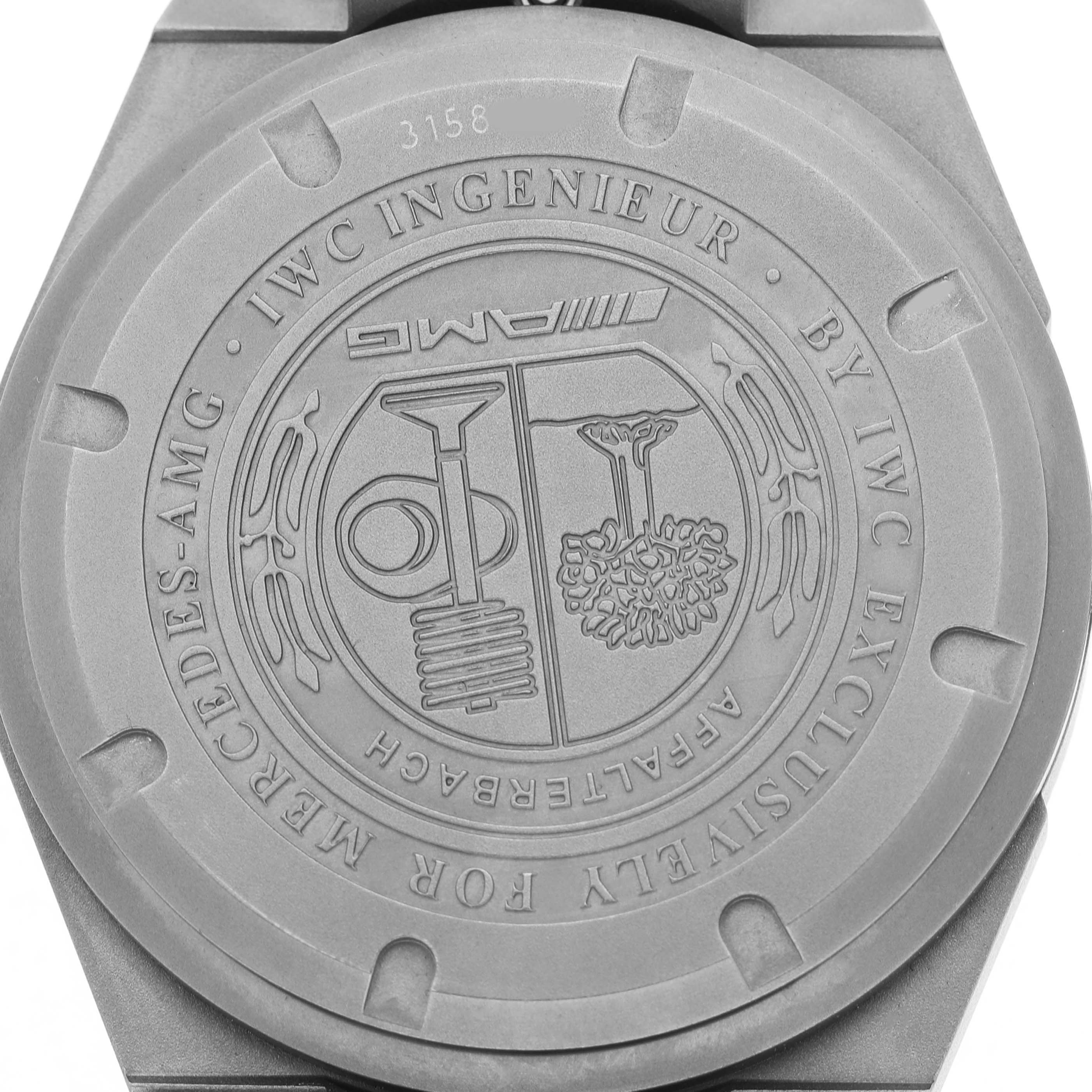 The image shows the back case of the IWC Ingenieur IW322702 Men's Titanium Black Dial watch, featuring AMG branding and intricate engravings.