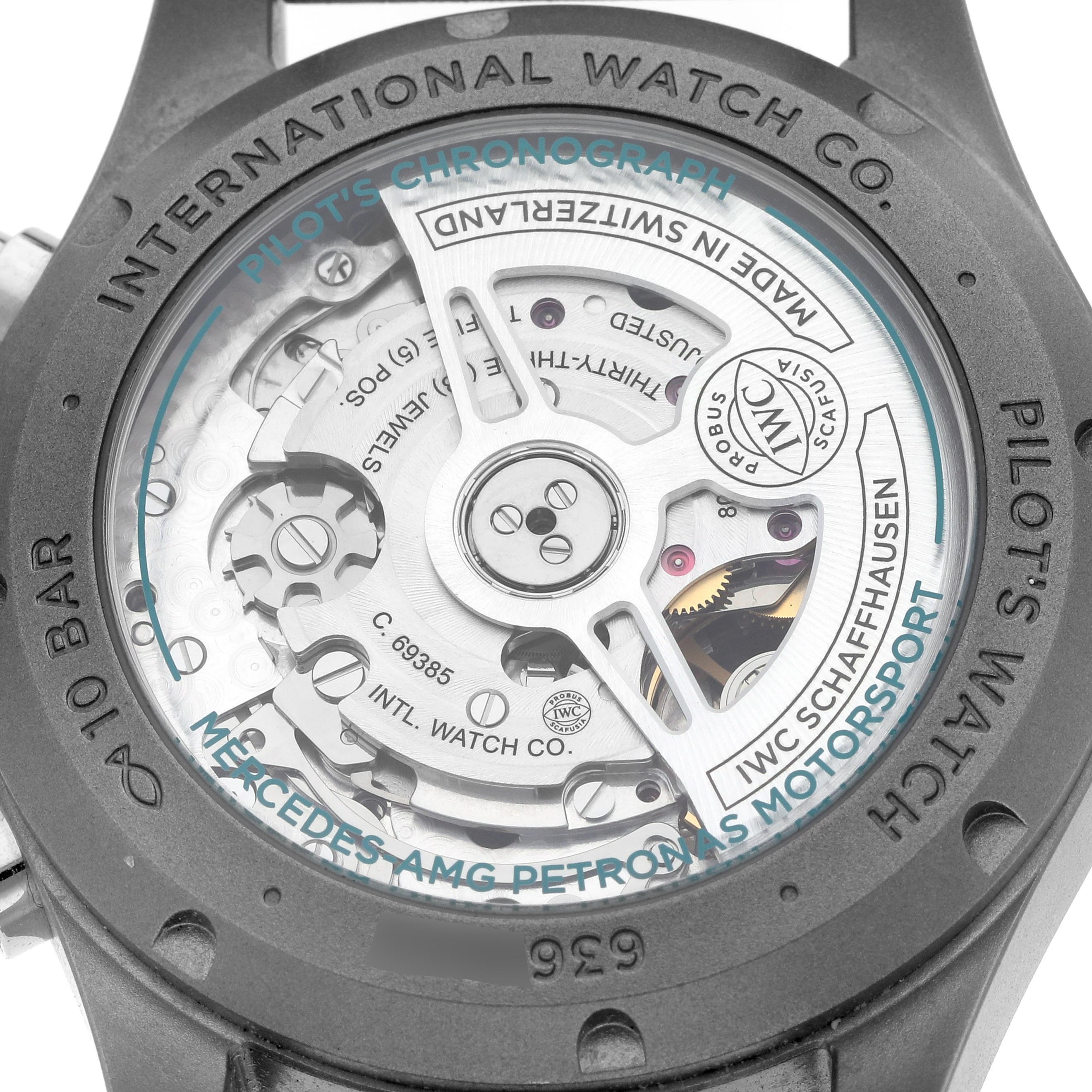 The image shows the back view of the IWC Pilot IW388108 Men's Titanium Black Dial model, highlighting the internal movement through a transparent case back.