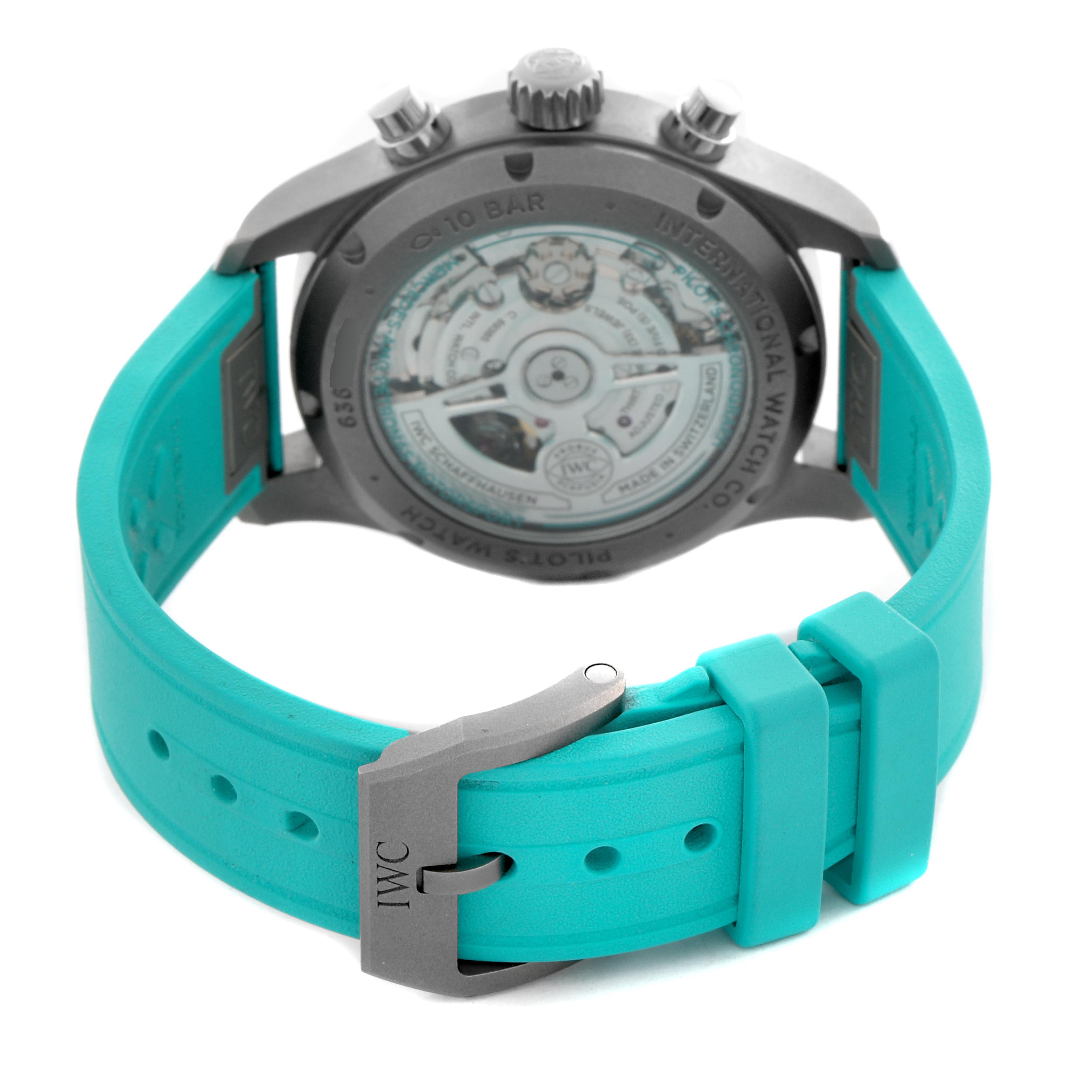 The IWC Pilot IW388108 Men's Titanium Black Dial watch is shown from the back, highlighting the case back, movement, and turquoise strap with branded buckle.