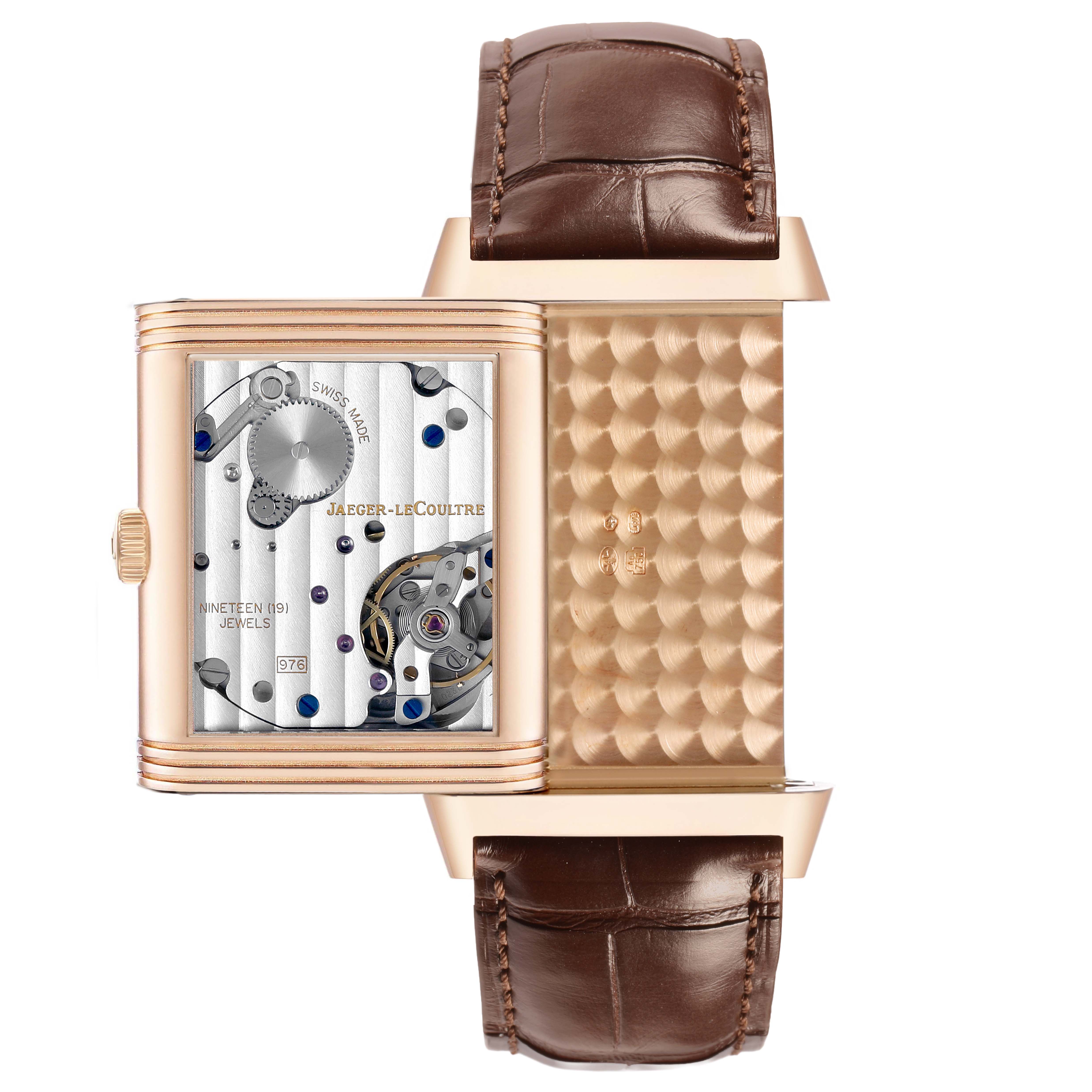 This image shows the Jaeger-LeCoultre Reverso watch with its case flipped to reveal the mechanical movement and internal details.
