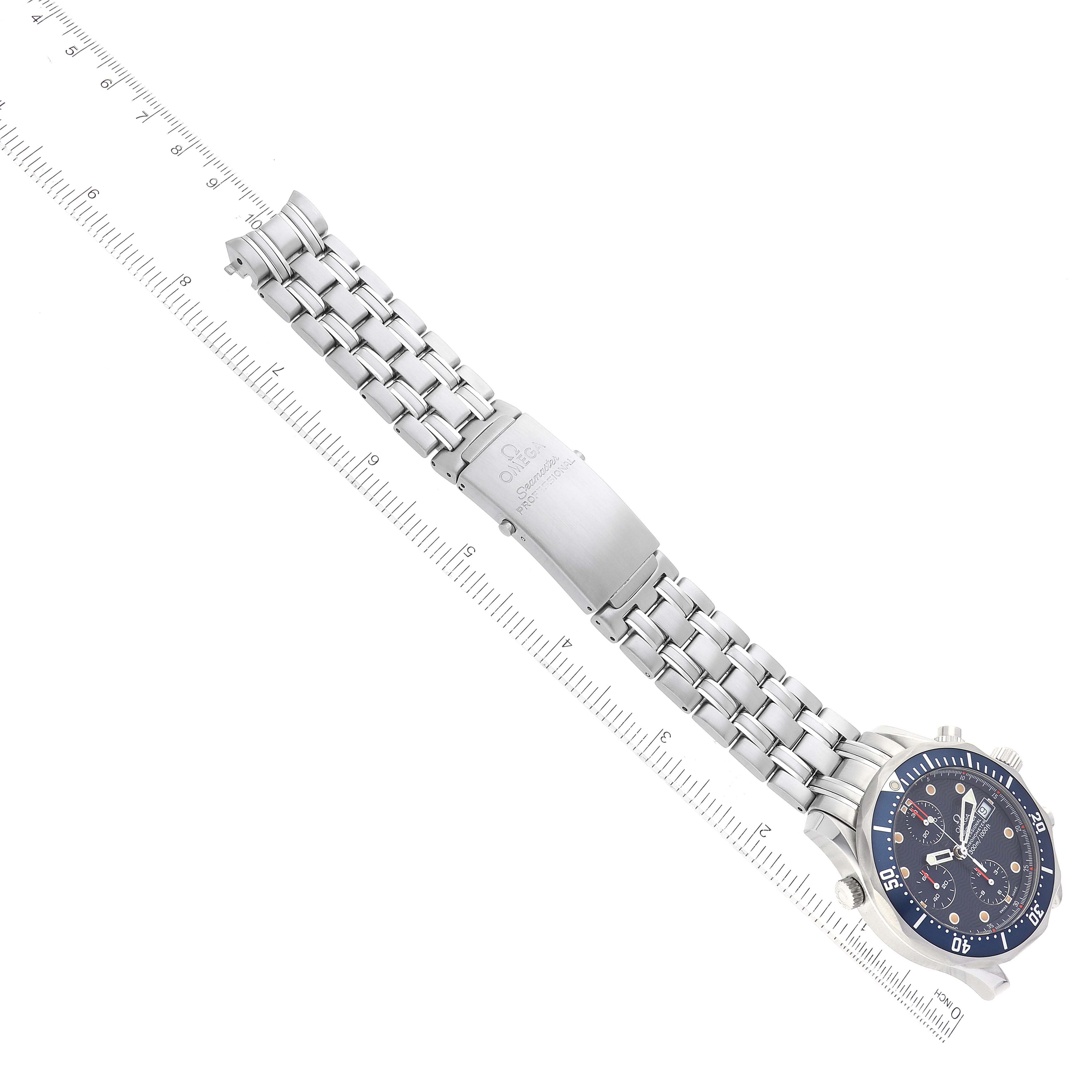 The image shows an angled top view of the Omega Seamaster 2599.80.00 Men's Stainless Steel Blue Dial 2599.80.00 Men's Stainless Steel Blue Dial, highlighting its bracelet and clasp, placed alongside a ruler for measurement.