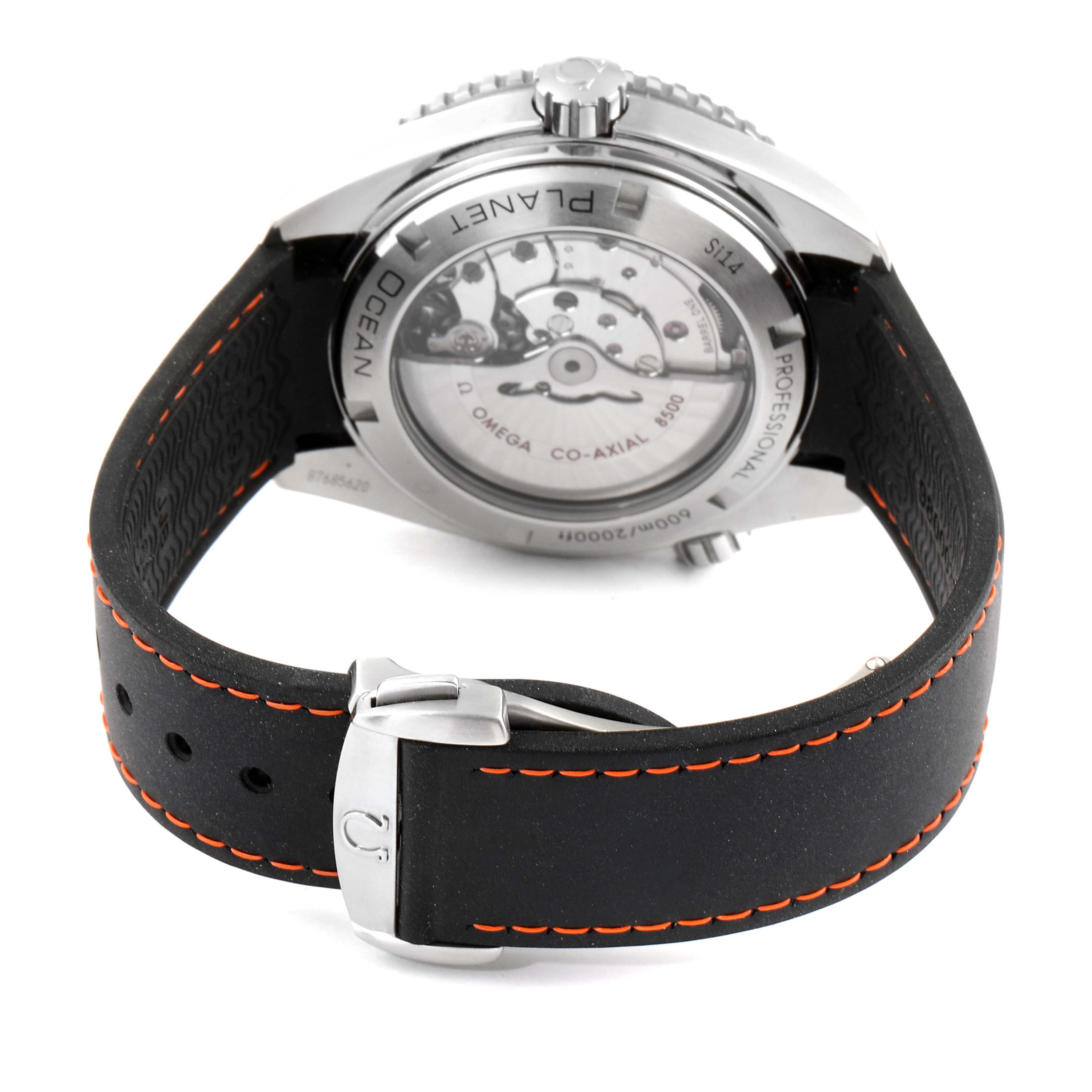 The image shows the back view of an Omega Seamaster 232.32.46.21.01.003 Men's Stainless Steel Black Dial 232.32.46.21.01.003 Men's Stainless Steel Black Dial watch, highlighting its caseback, inner mechanics, and black strap with orange stitching.