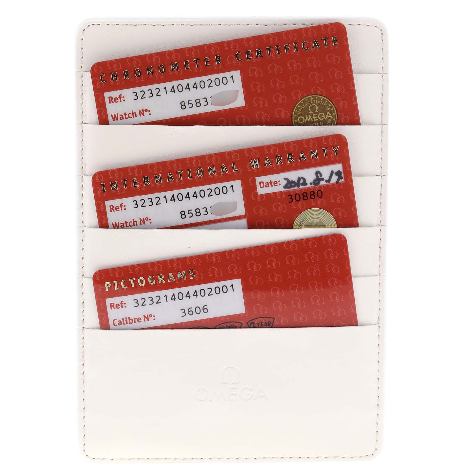 This image shows three red Omega cards: a Chronometer Certificate, an International Warranty, and a Pictogram, in a white holder.