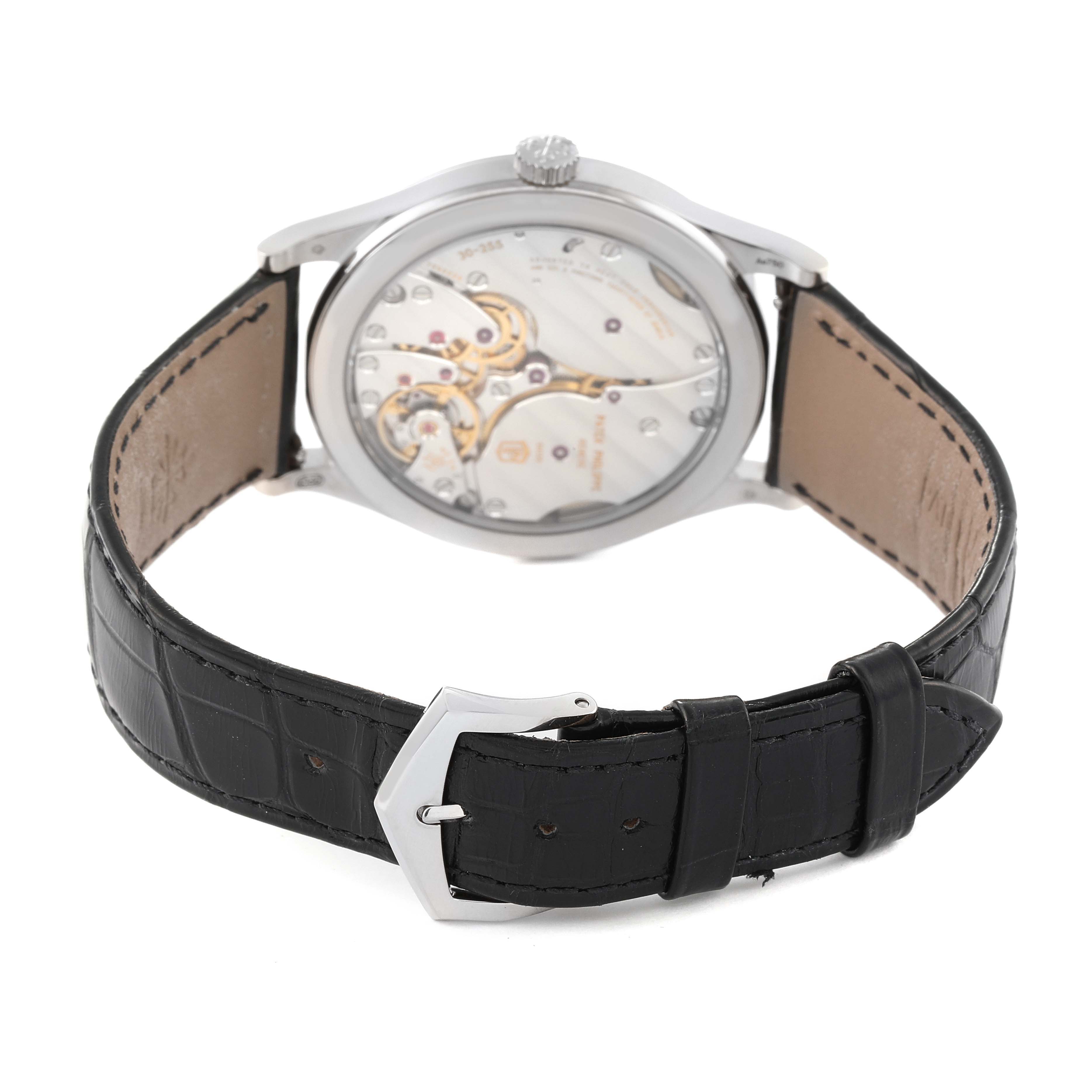 The image shows the back view of the Patek Philippe Calatrava 6119G-001 Men's White Gold Grey Dial 6119G-001 Men's White Gold Grey Dial watch, displaying its movement and black leather strap.